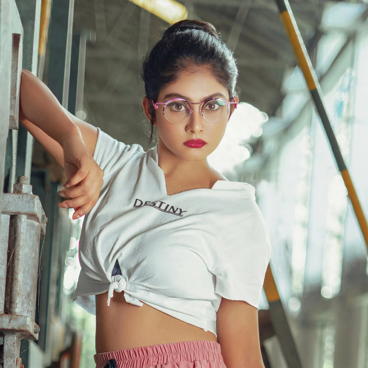 Model wearing Barledear Fuchsia Marble eyeglasses in a lifestyle portrait showing retro round semi-rimless titanium frame style