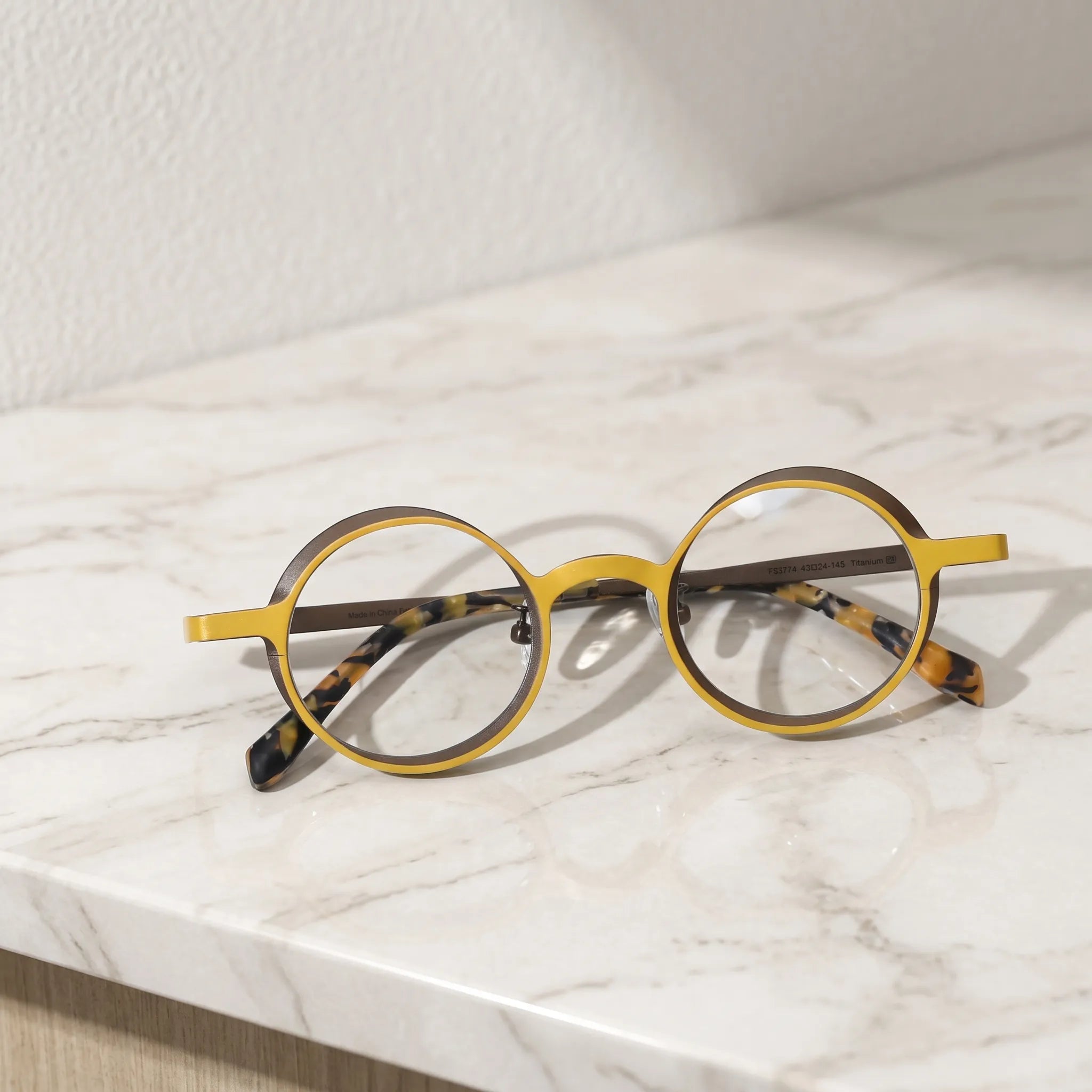 Barledear Golden Walnut round pure titanium eyeglasses folded display showing slim temples patterned temple tips and adjustable nose pads