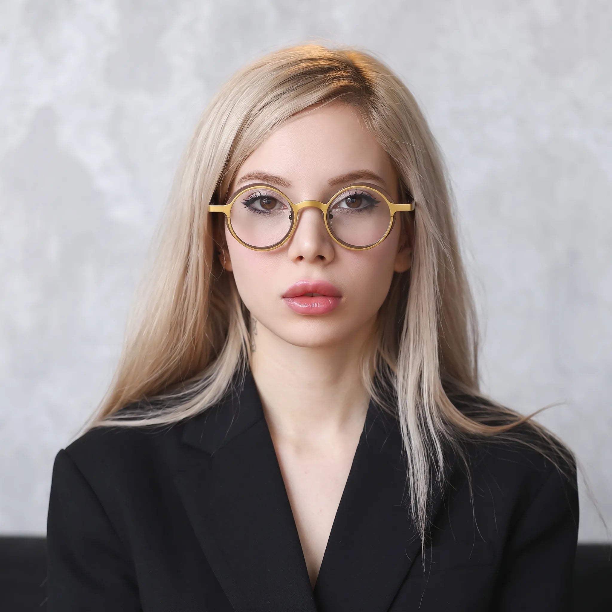 Model wearing Barledear Golden Walnut round pure titanium eyeglasses in a lifestyle portrait showing a lightweight design for everyday wear