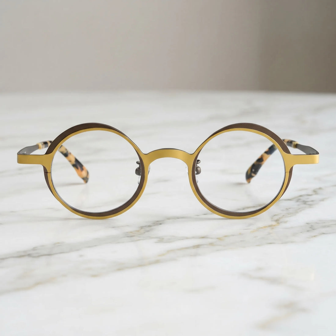Barledear Golden Walnut round titanium eyeglasses displayed in a clean lifestyle scene showing the artistic color-block design in warm golden yellow and deep brown
