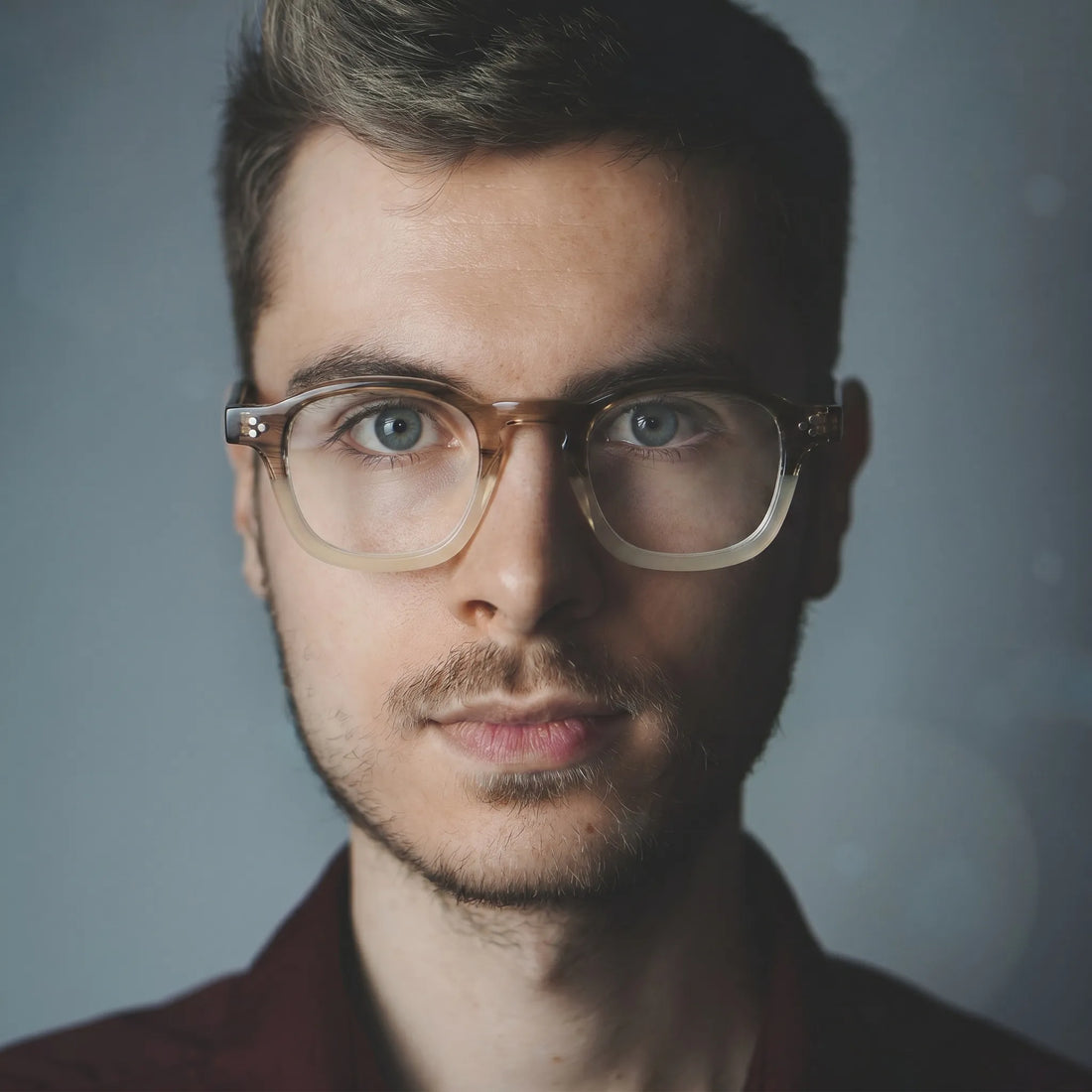 model wearing Barledear Honey Crystal Brown eyeglasses in a lifestyle portrait with retro square acetate frame