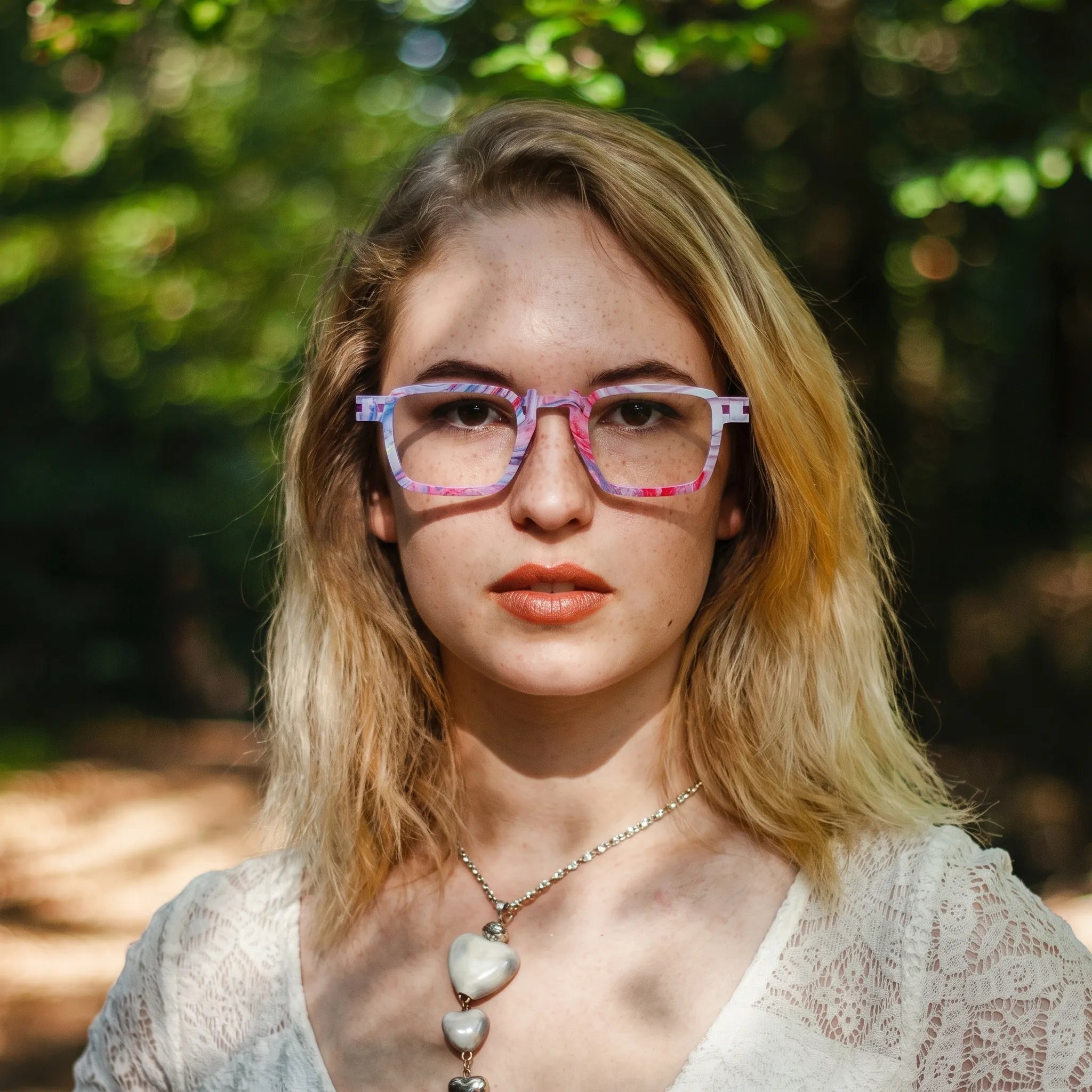 Model wearing Barledear Lavender Rose Mosaic geometric square titanium eyeglasses in a lifestyle portrait for expressive everyday styling