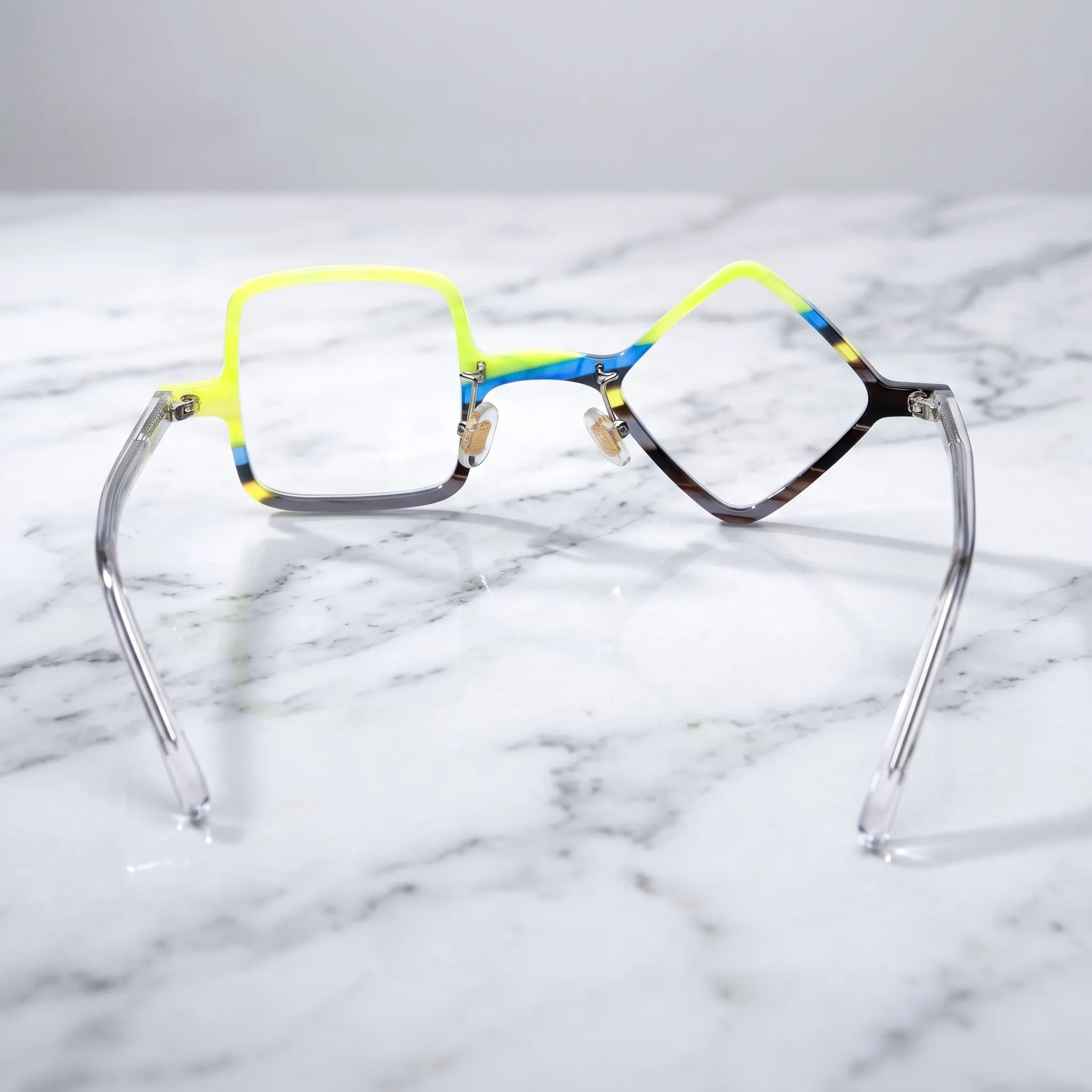 Barledear Lime Smoke asymmetric geometric acetate eyeglasses back view showing the mismatched lens shapes, adjustable nose pads, and transparent temple construction.