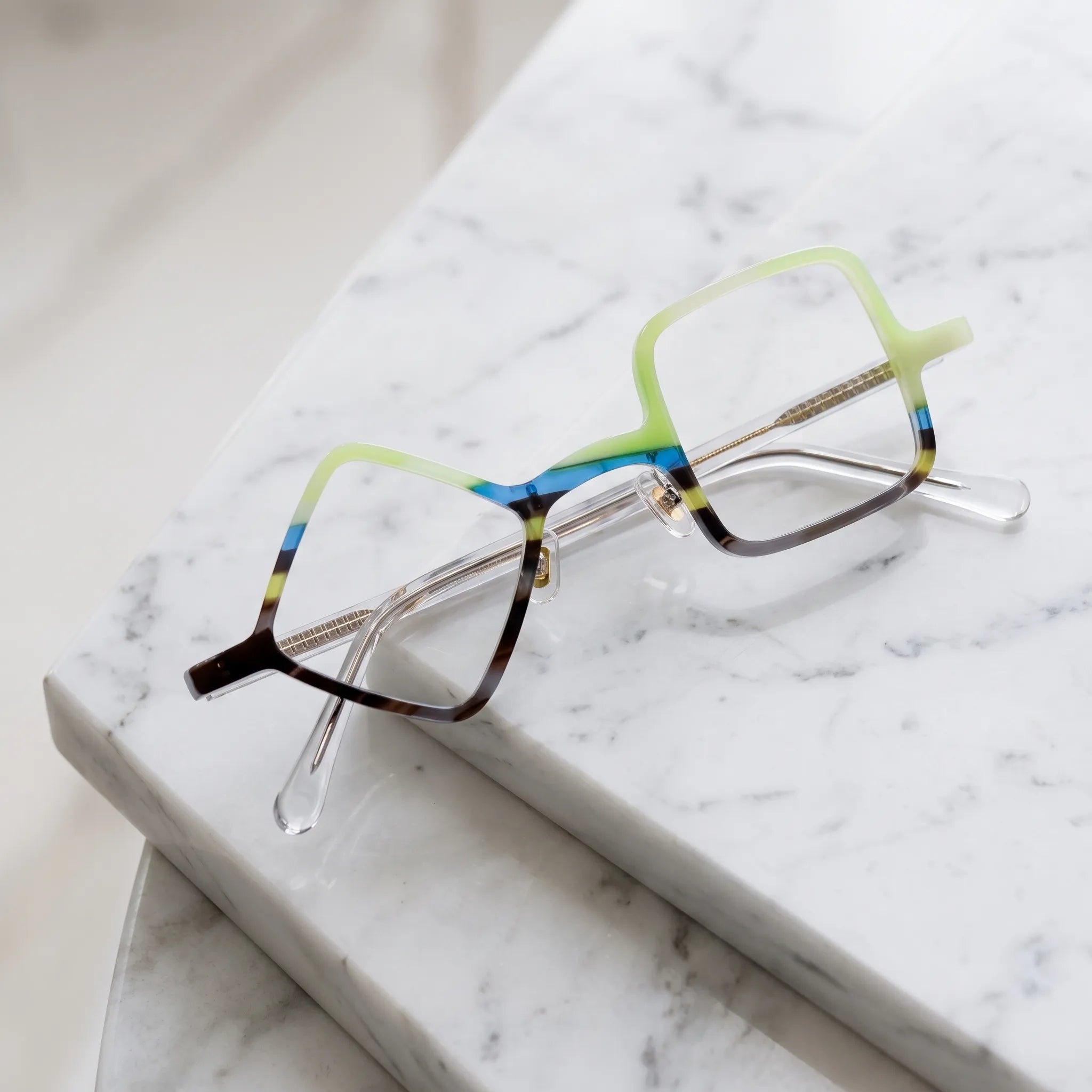Barledear Lime Smoke asymmetric geometric acetate eyeglasses folded display showing the multicolor front, adjustable nose pads, and transparent reinforced temples.
