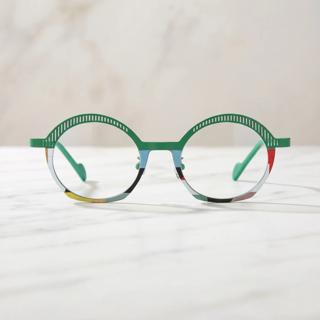Barledear Meadow Mosaic eyeglasses shown in a clean lifestyle front view with green slotted browline and artistic multicolor rim accents
