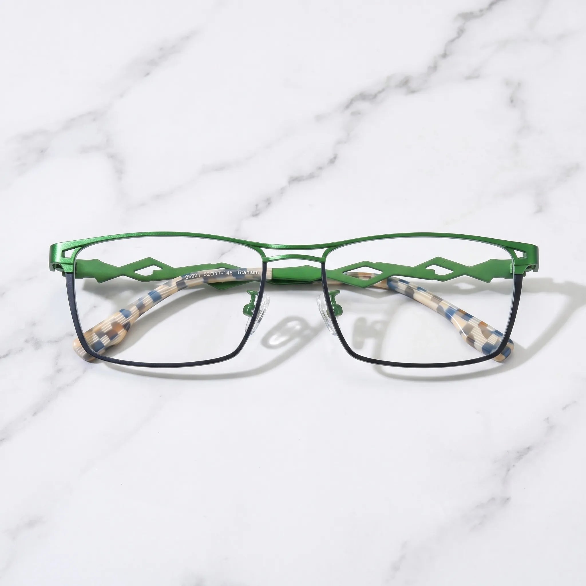 Barledear Meadow Navy Blue eyeglasses folded display showing geometric titanium temples and blue green patterned temple tips