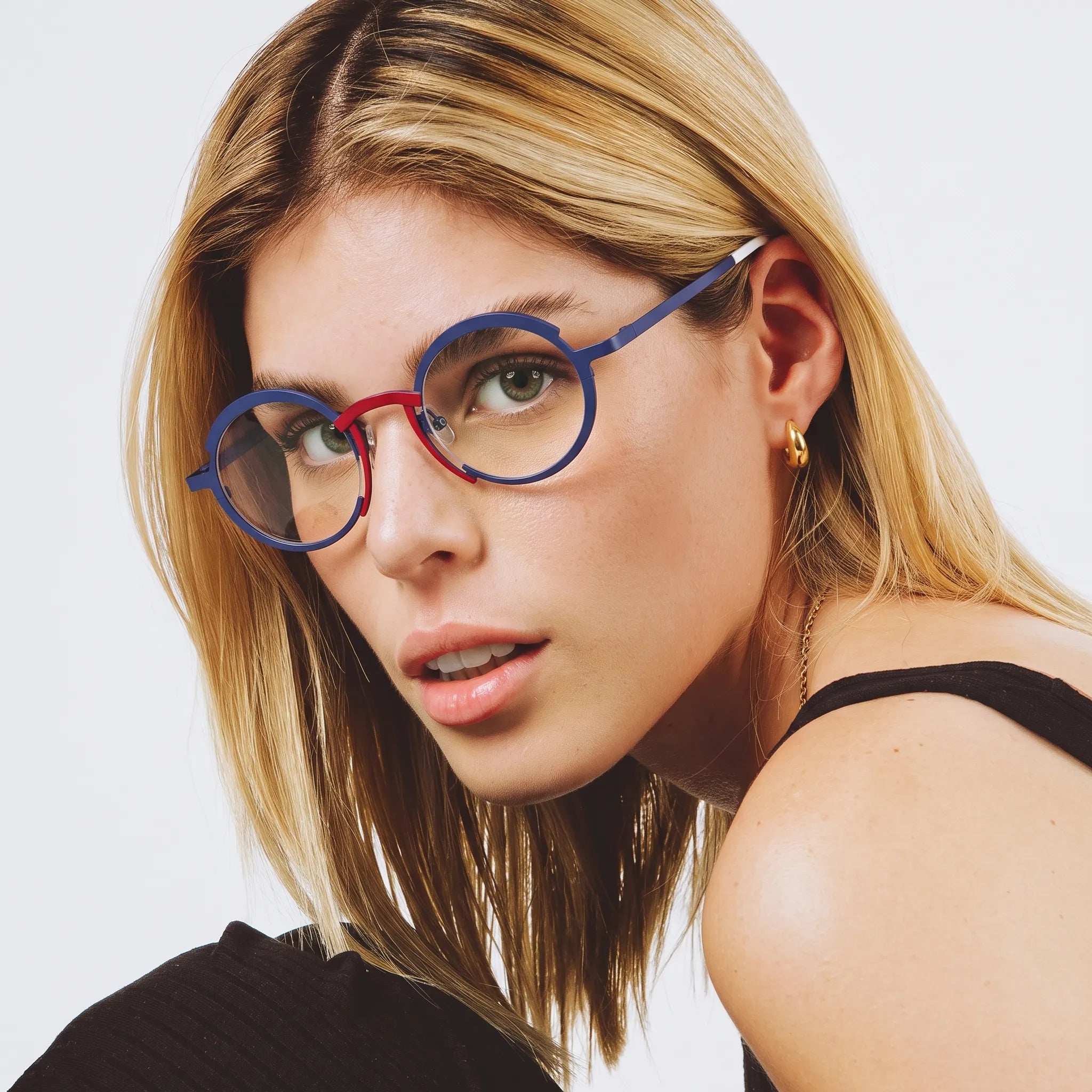 Model wearing Barledear Midnight Navy Crimson Red titanium round eyeglasses worn in a stylish lifestyle portrait showing the medium-fit frame