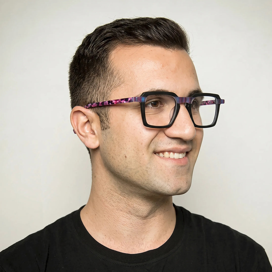 Model wearing Barledear Midnight Orchid square eyeglasses in a contemporary lifestyle portrait