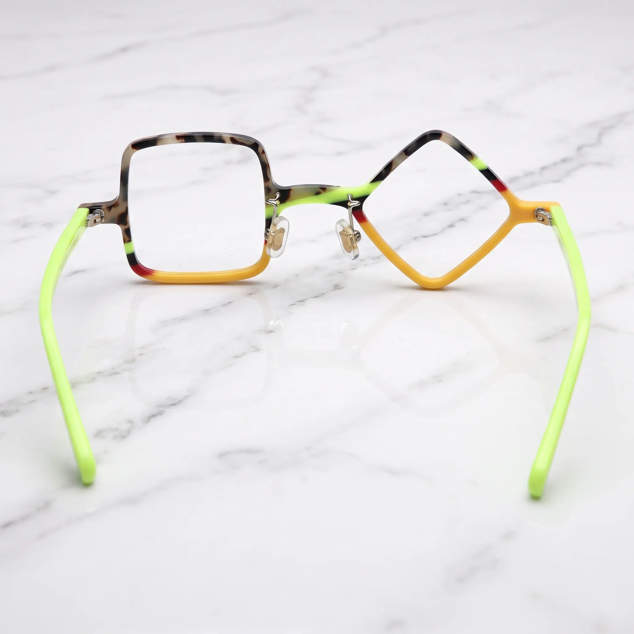 Barledear Neon Tortoise asymmetric geometric acetate eyeglasses back view showing the mismatched lens shapes, adjustable nose pads, and neon-lime temple structure.