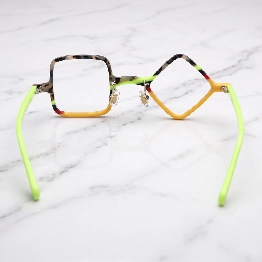 Barledear Neon Tortoise asymmetric geometric acetate eyeglasses back view showing the mismatched lens shapes, adjustable nose pads, and neon-lime temple structure.