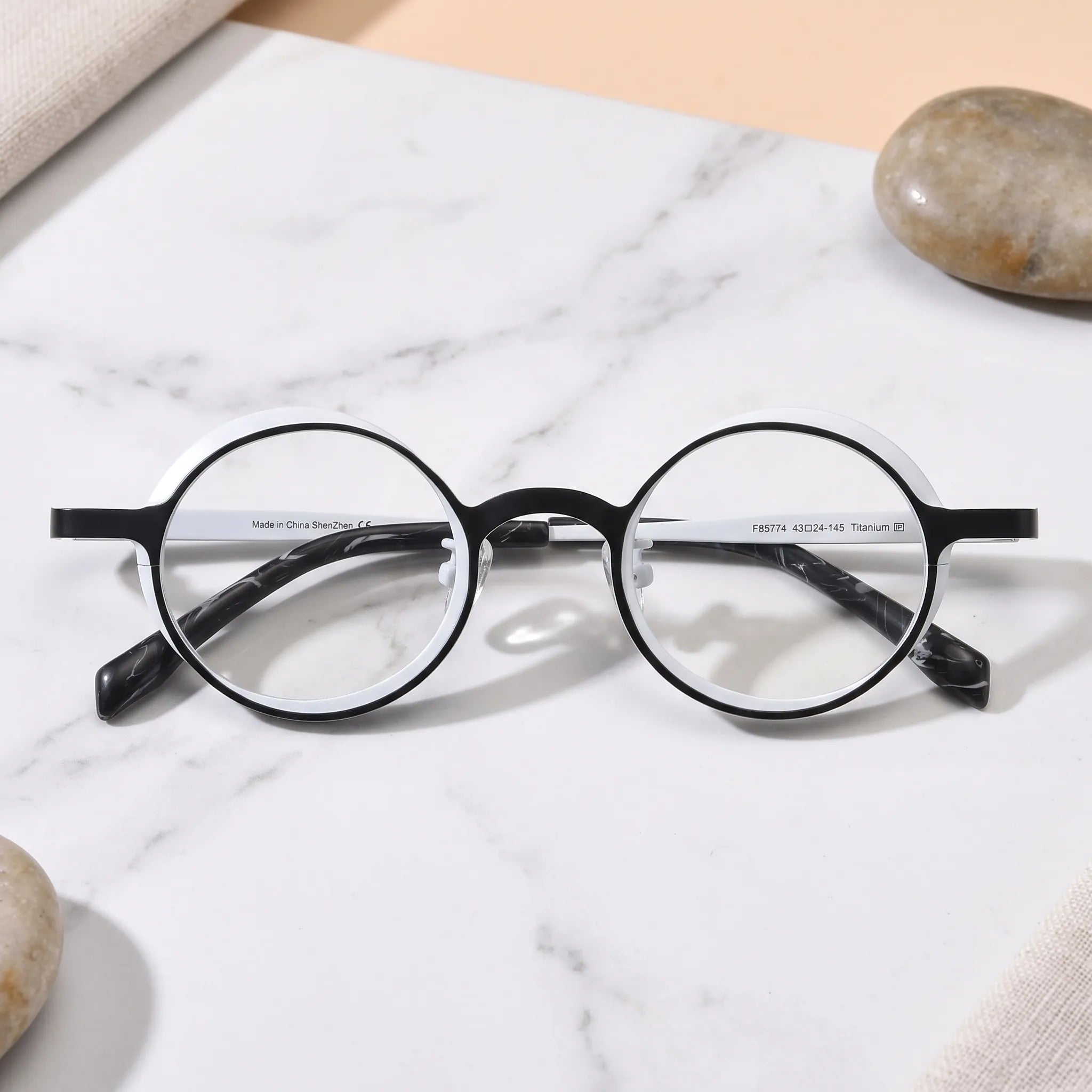 Barledear Onyx Crystal round pure titanium eyeglasses folded display showing slim temples patterned temple tips and adjustable nose pads