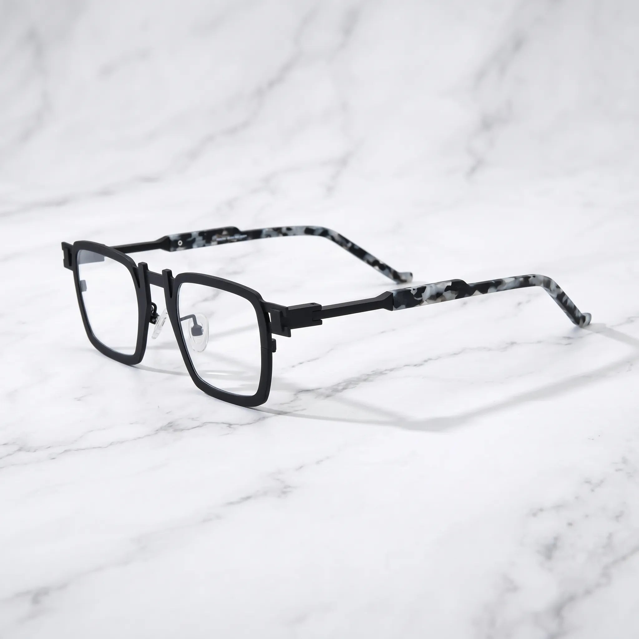 Barledear Onyx Smoke Marble eyeglasses angled side view showing slim titanium temples, geometric side joint, and adjustable nose pads