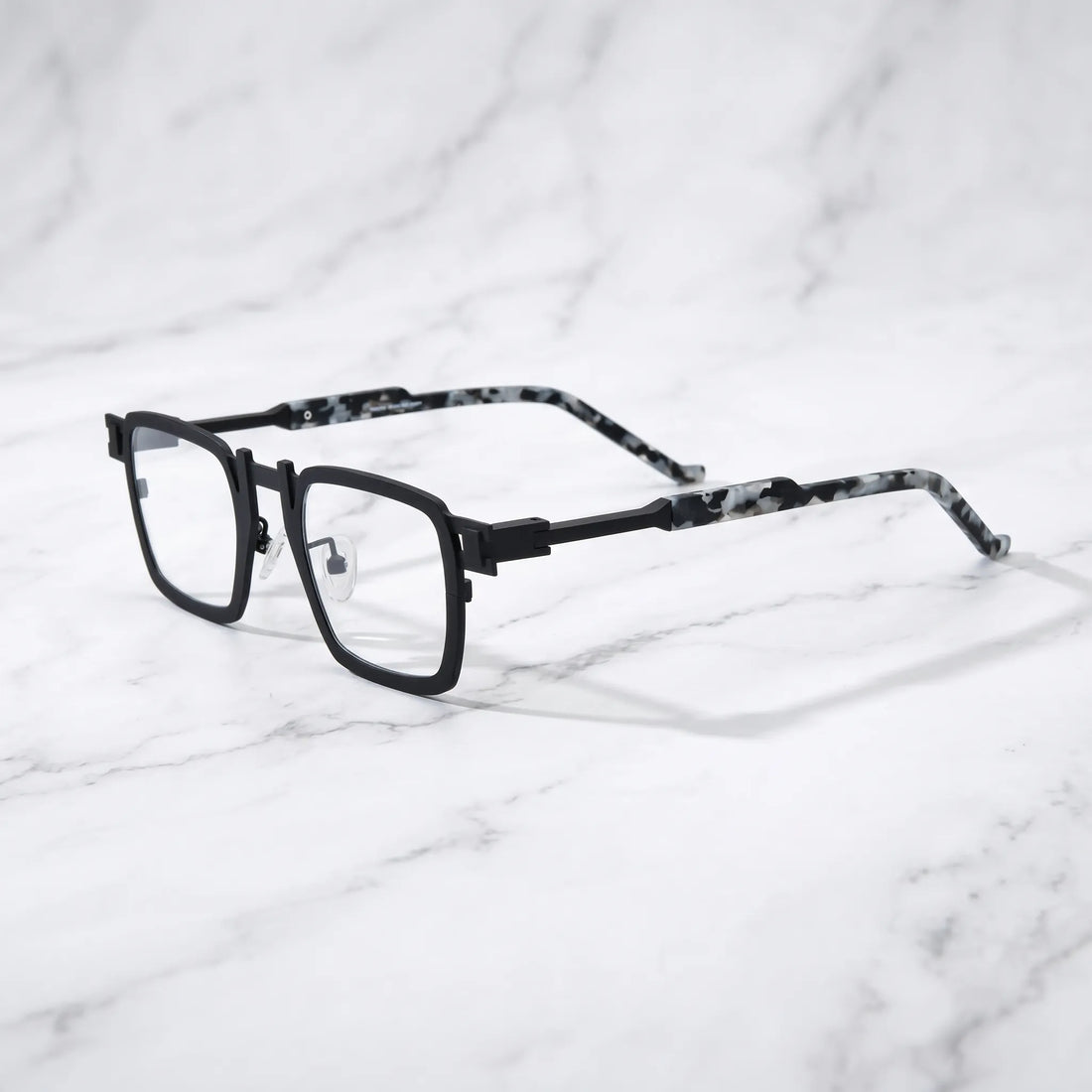 Barledear Onyx Smoke Marble eyeglasses angled side view showing slim titanium temples, geometric side joint, and adjustable nose pads
