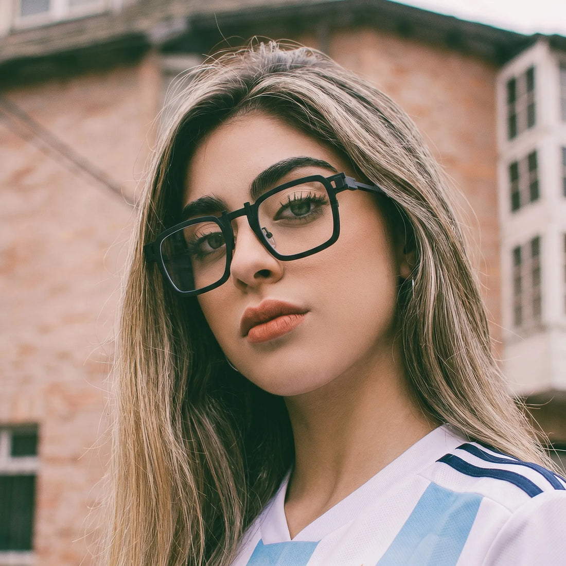 Model wearing Barledear Onyx Smoke Marble geometric square titanium eyeglasses in a lifestyle portrait for bold minimalist styling