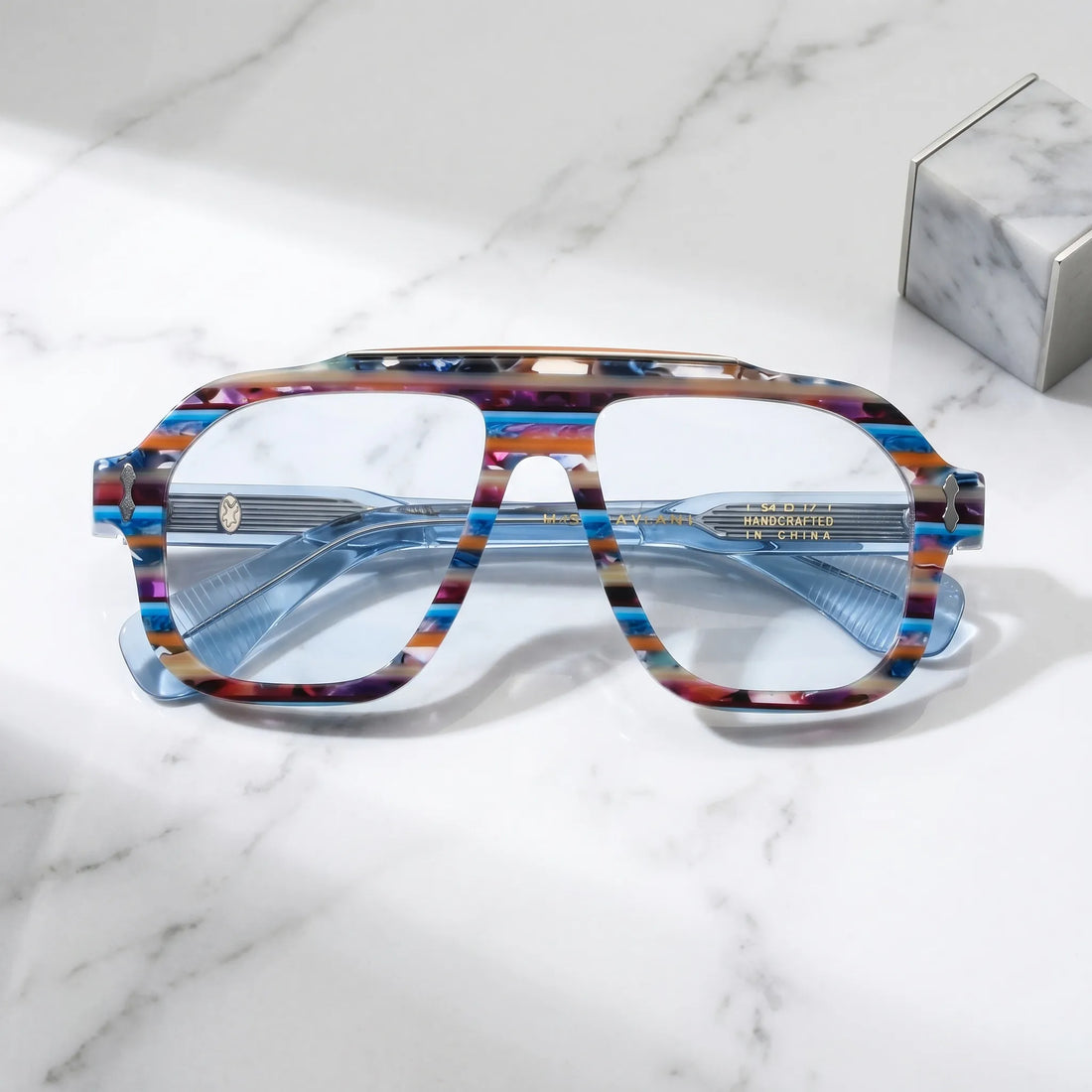 Barledear Prism Blue Mosaic eyeglasses folded display showing the thick acetate front, translucent blue temples and decorative metal hinge details