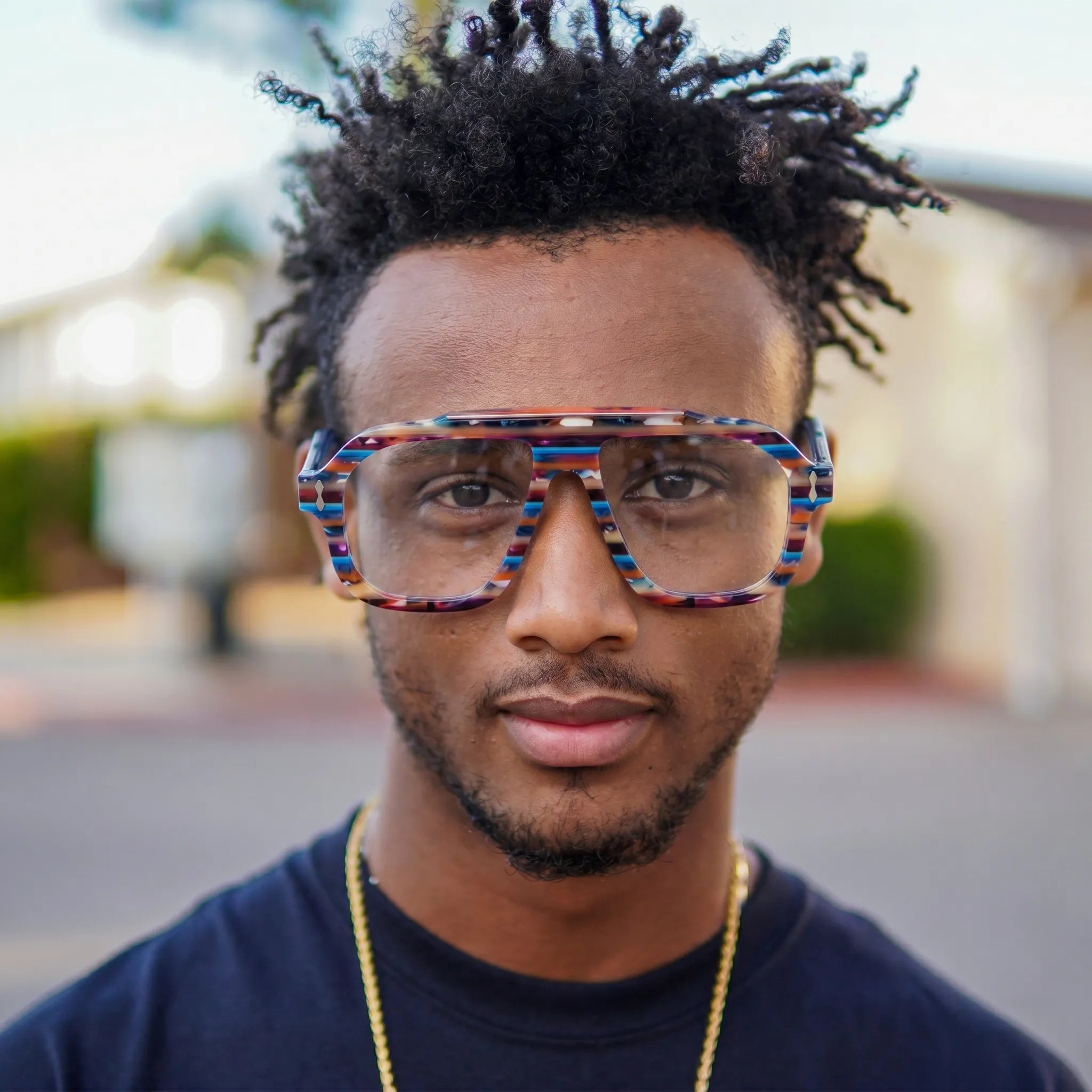 Adult model wearing Barledear Prism Blue Mosaic square aviator acetate eyeglasses for a bold colorful casual eyewear look