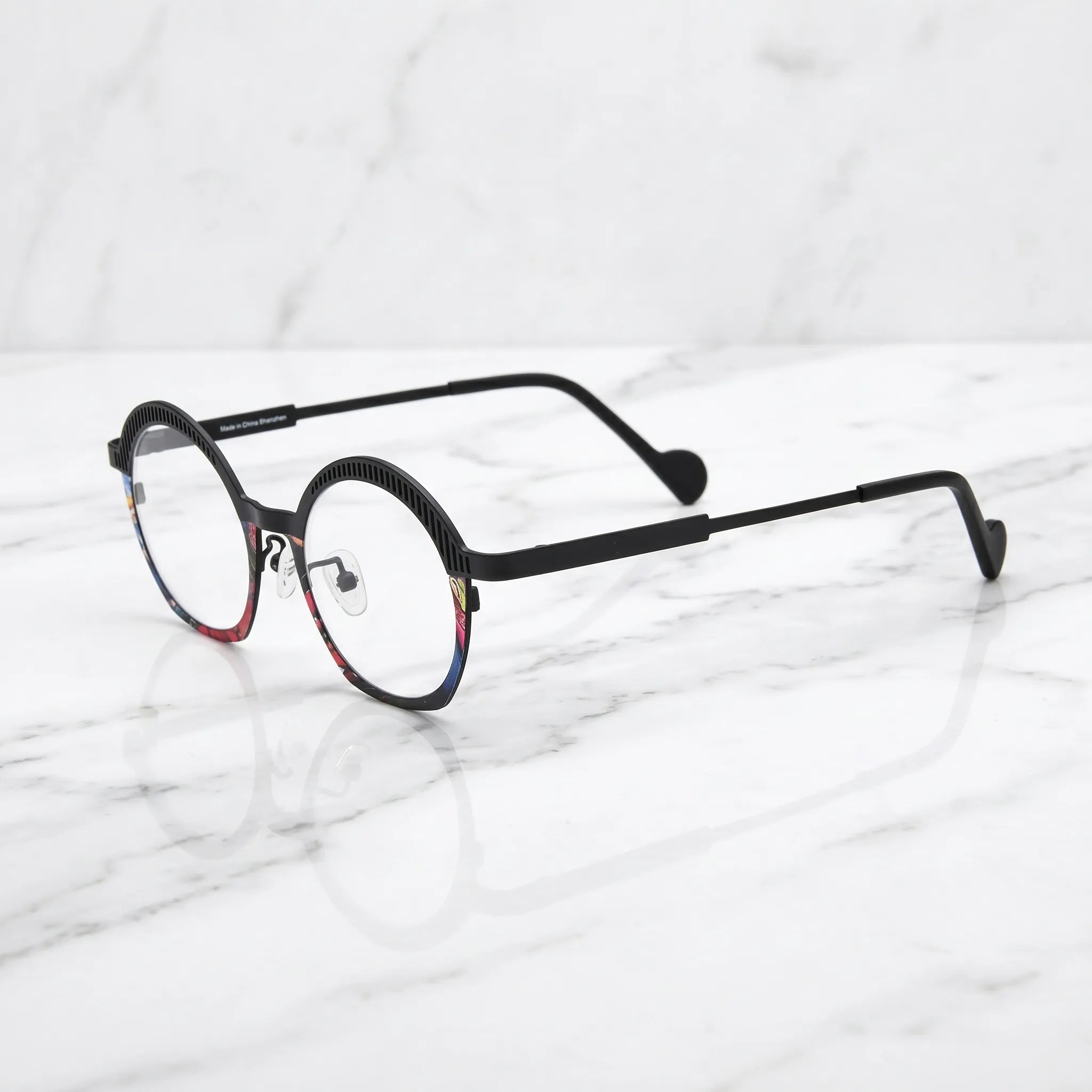 Barledear Prism Noir eyeglasses angled side view showing slim titanium temples, curved black temple tips, and colorful mosaic front detail