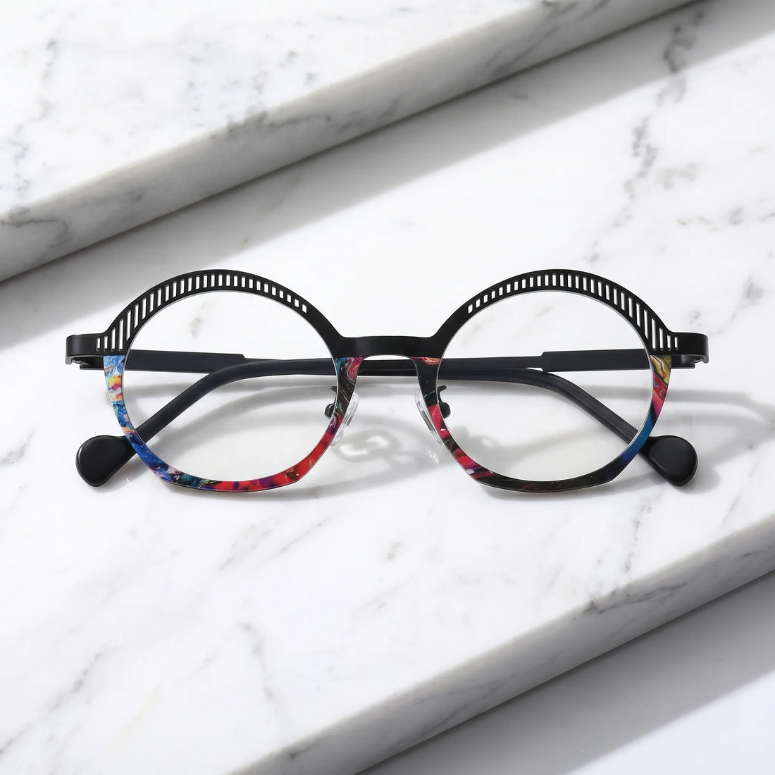 Barledear Prism Noir eyeglasses folded display showing slim black titanium temples, clear nose pads, and artistic geometric oval frame
