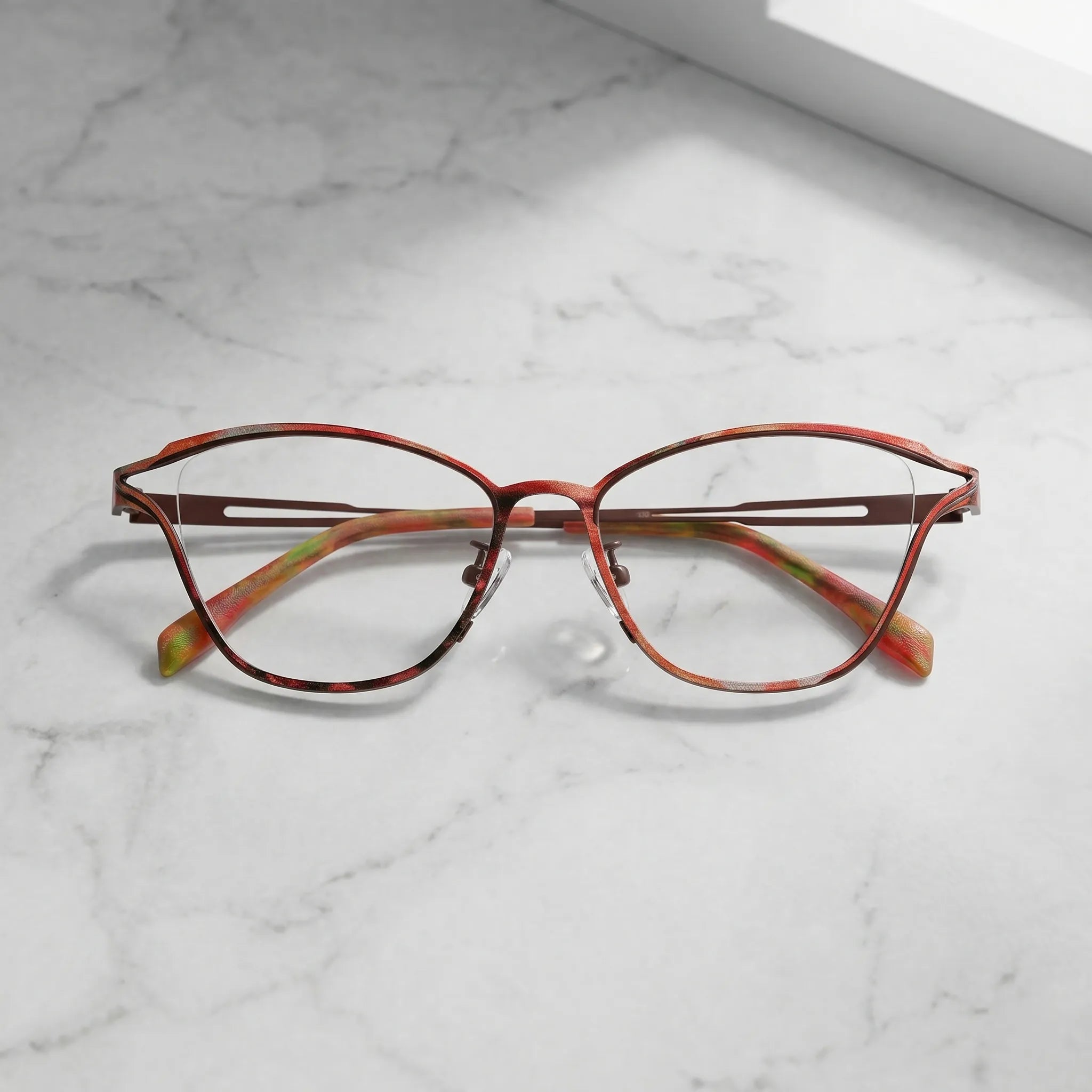 Barledear Rosewood Amber eyeglasses folded display showing slim titanium frame and warm patterned temple design