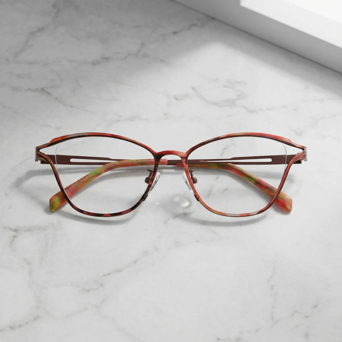 Barledear Rosewood Amber eyeglasses folded display showing slim titanium frame and warm patterned temple design