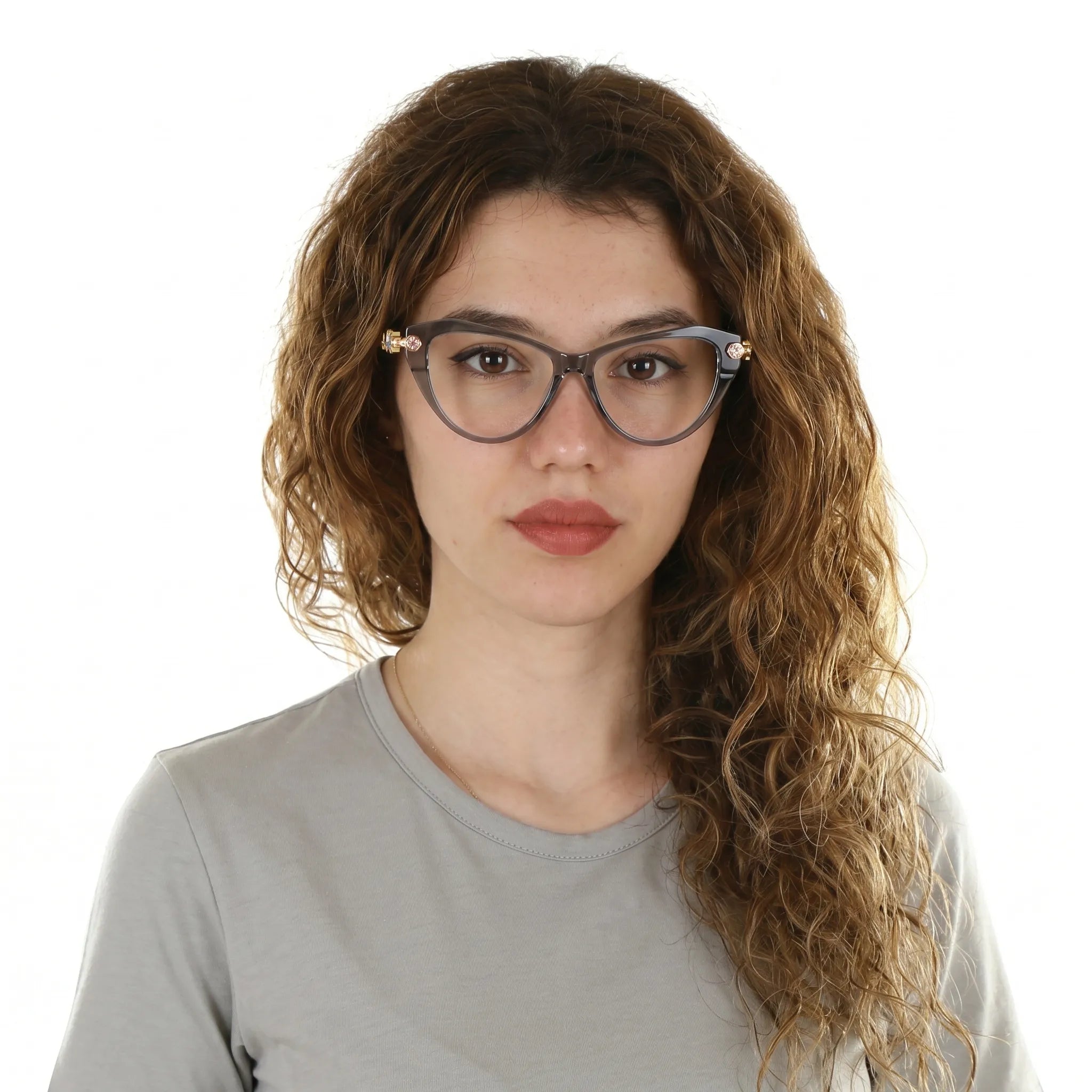 Adult woman wearing Barledear Smoke Quartz geometric cat-eye eyeglasses in a polished modern lifestyle portrait