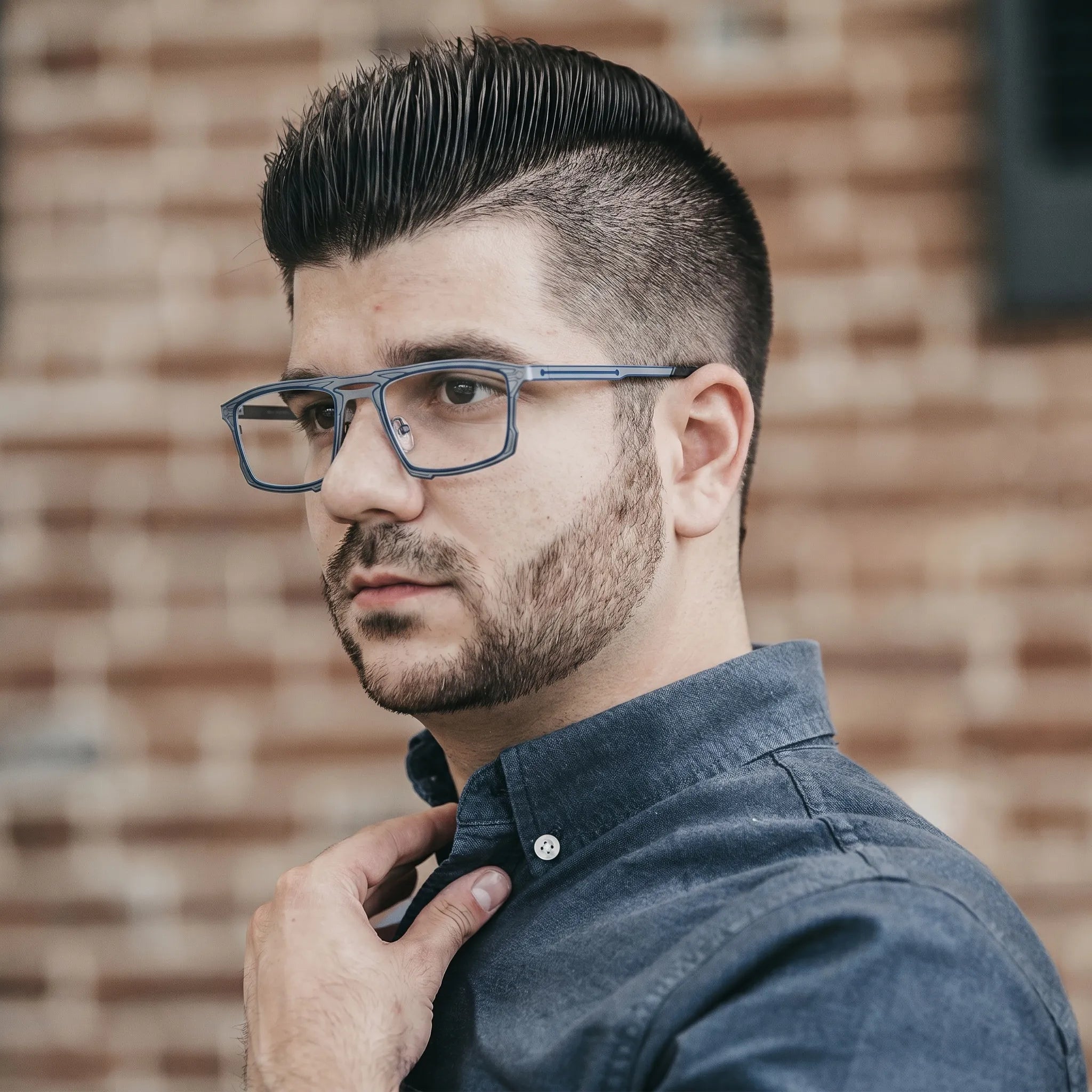 Model wearing Barledear Steel Blue Gray eyeglasses in a lifestyle portrait with lightweight square titanium frame styling