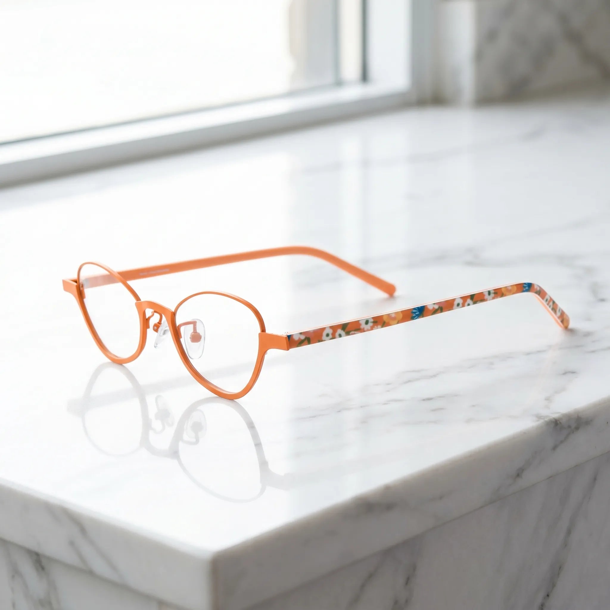 Barledear Tangerine Bloom eyeglasses angled side view showing orange temples clear nose pads and bridge detail