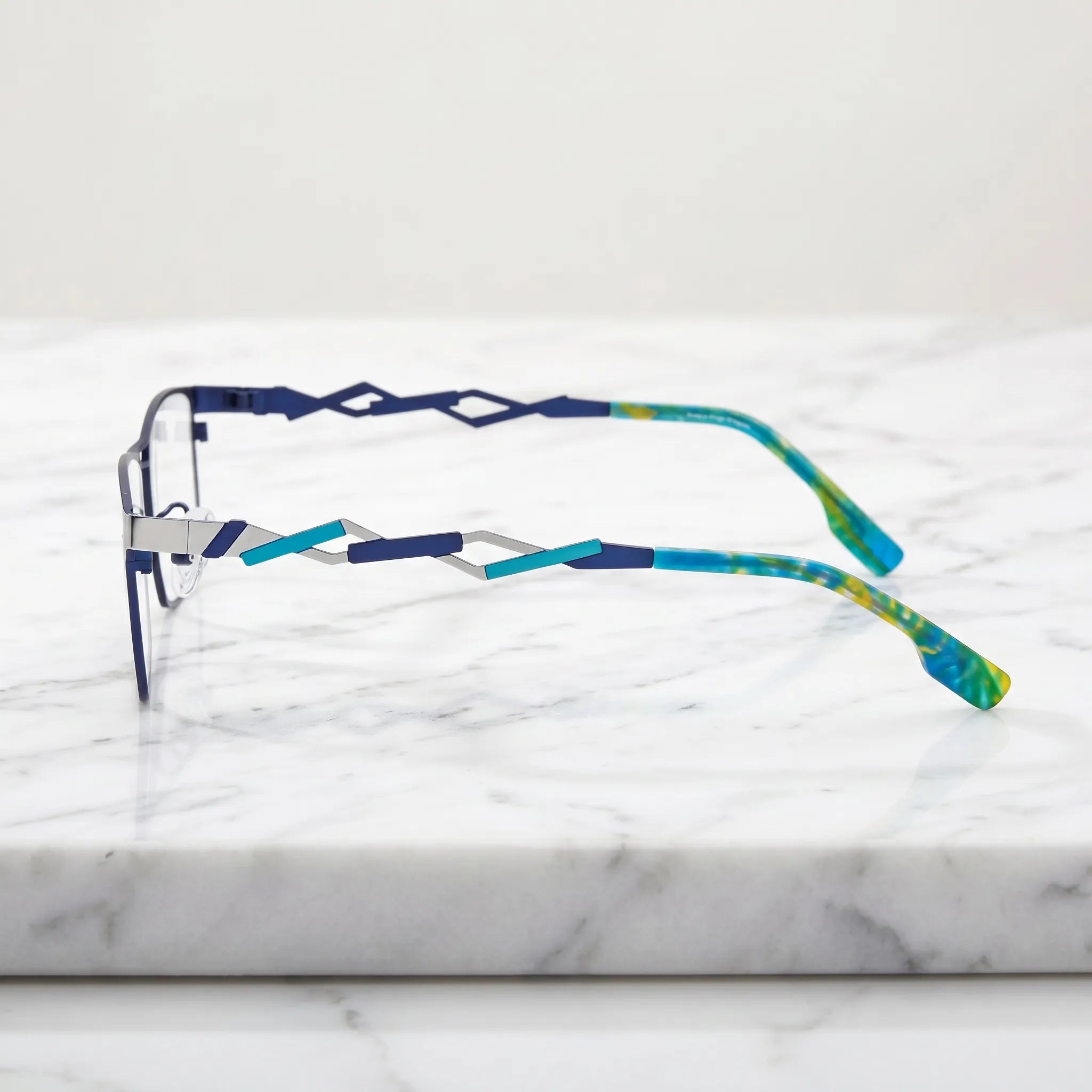Barledear Titan Sky Blue eyeglasses angled side view showing futuristic geometric cutout temples and slim bridge detail