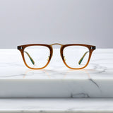 Front-facing view of VoyueLens™ VL19214 brown acetate square eyeglasses showcasing polished frame details and bold silhouette.