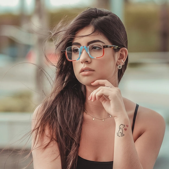 Model wearing  VL19352 Crystal Blue Tortoise semi-rimless square eyeglasses, showing the fit and colorful statement acetate frame