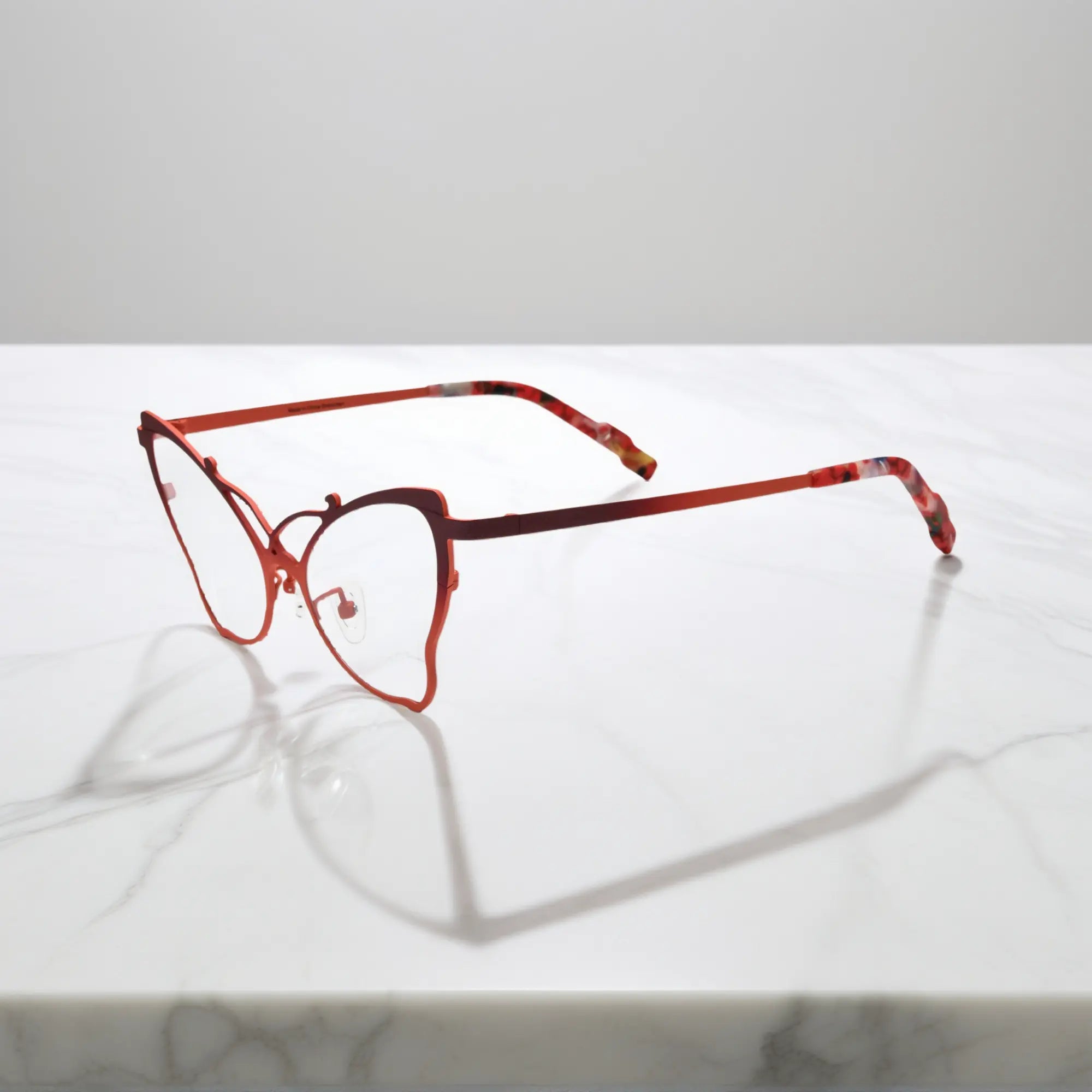 Side of VoyueLens™ VL185862 titanium butterfly eyeglasses in Amber Orange – a lightweight, colorful, vintage-inspired, prescription ready frame designed for unique artistic style and everyday comfort.