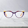 Front View of VoyueLens™ Amethyst Sunrise cat-eye eyeglasses with purple-to-yellow gradient and signature lace-pattern design.