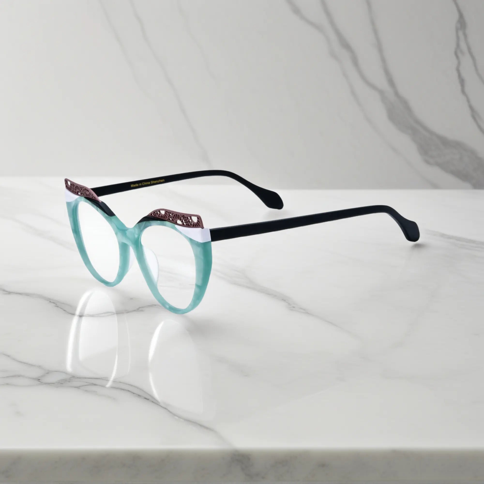 Side View of VoyueLens™ Aqua Frost cat-eye eyeglasses with blue-green gradient and signature lace-pattern design.