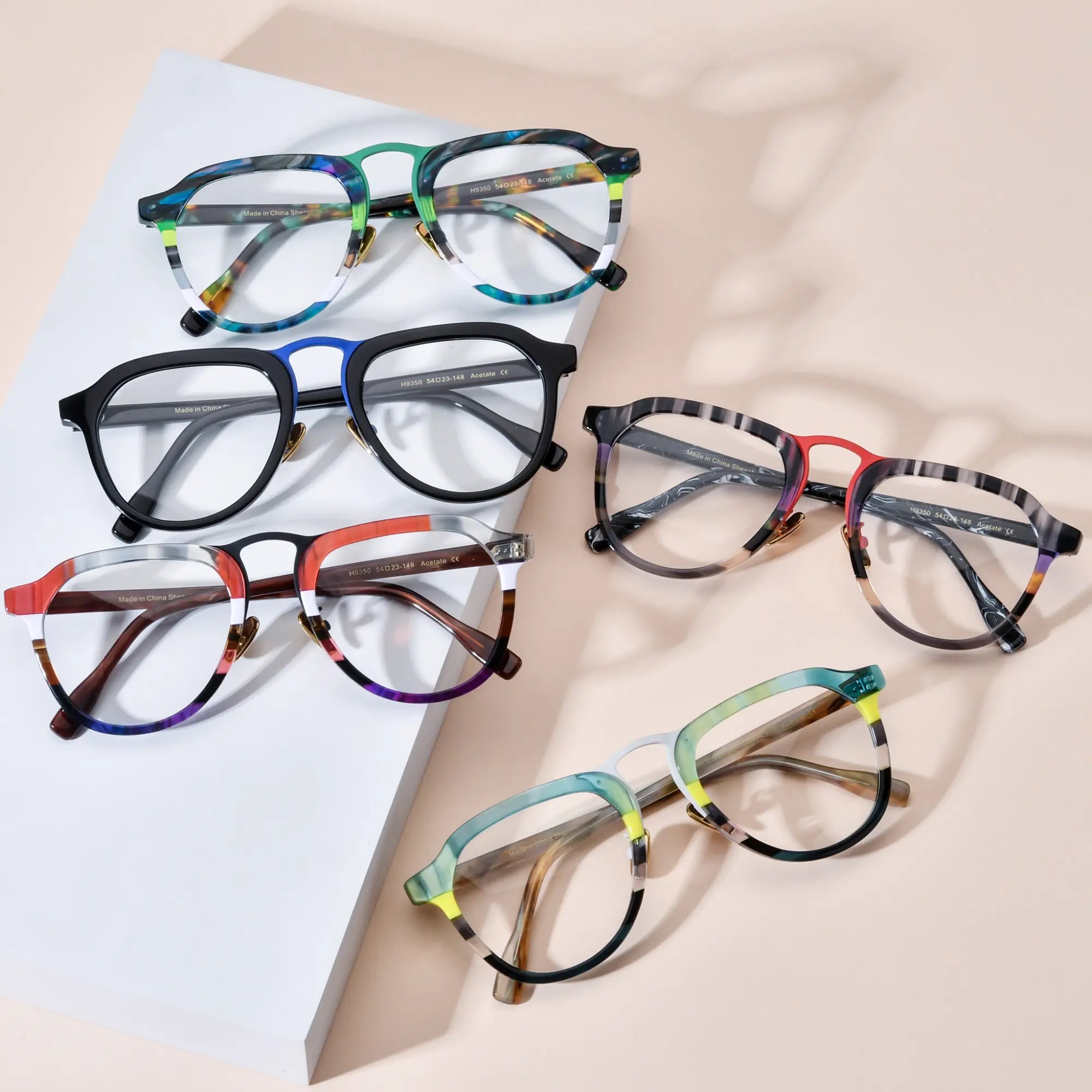 Group display of VoyueLens Artist Series aviator glasses showing all five acetate color variants including Forest Aurora, Midnight Blue Accent, Crimson Fade on Walnut, Scarlet Marble Mix, and Mint Cream Tortoise