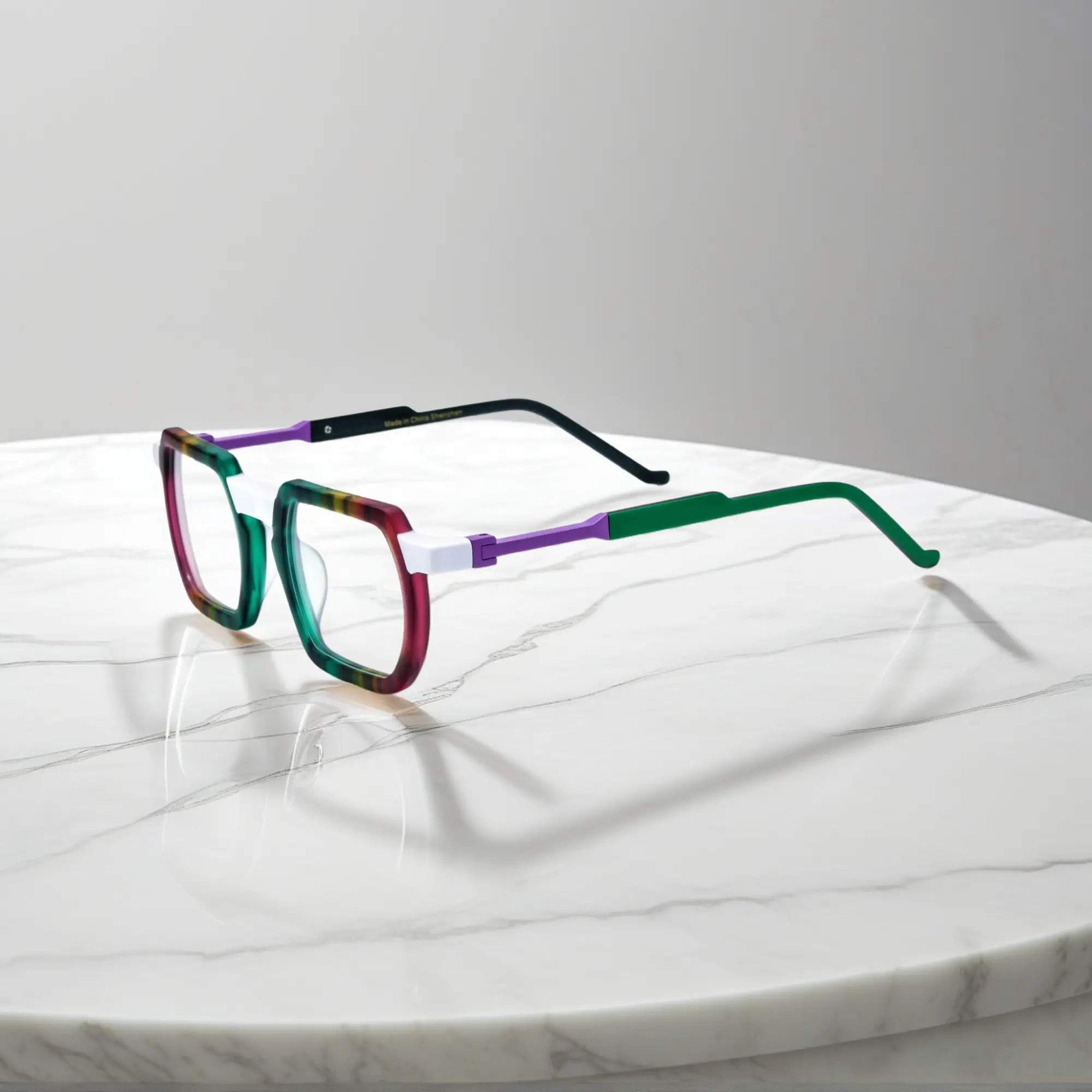 Side angle showcasing purple, blue, and gold gradient along acetate temples with unique urban appeal