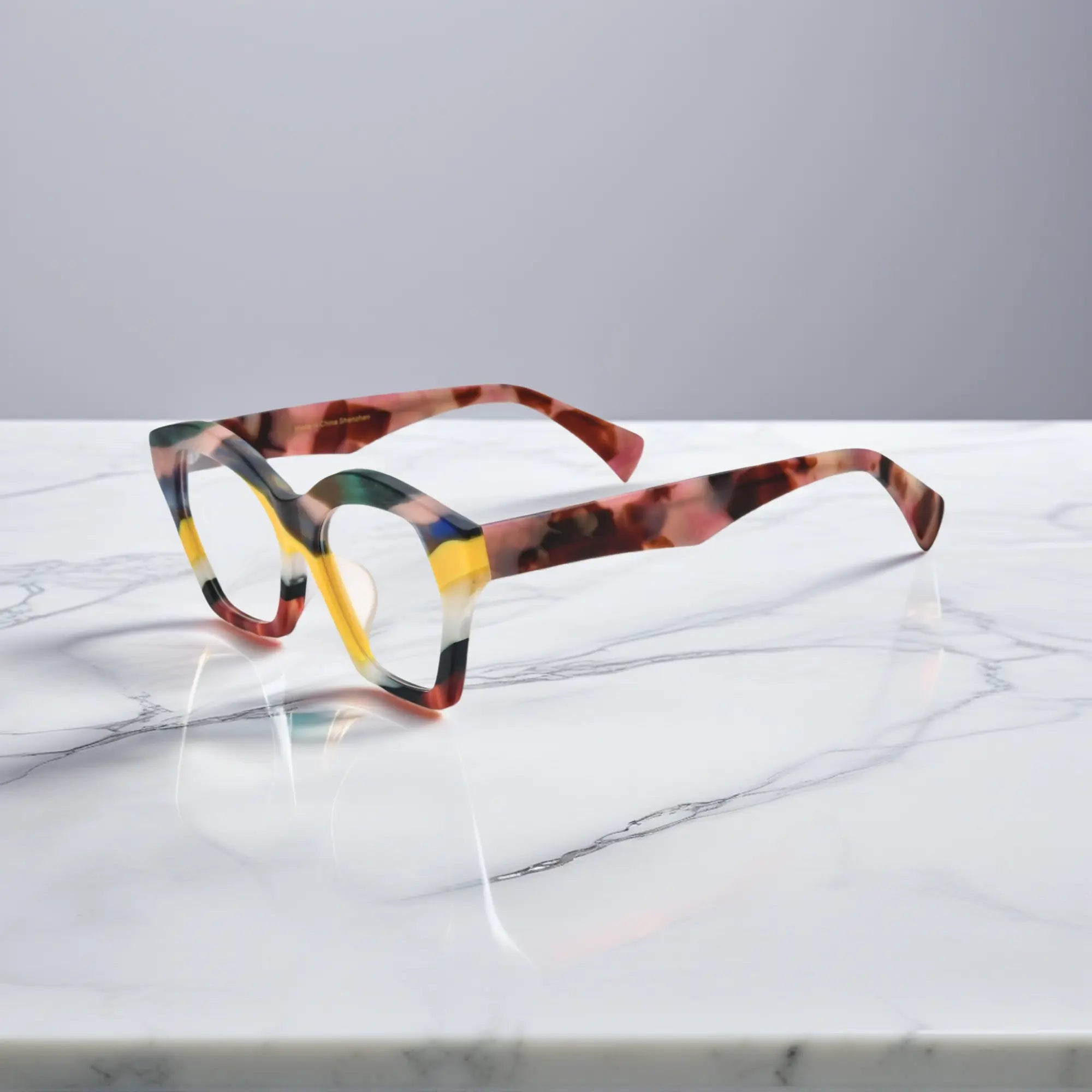 Profile view of Aurora Mosaic cat-eye glasses showing side texture and layered acetate colors.