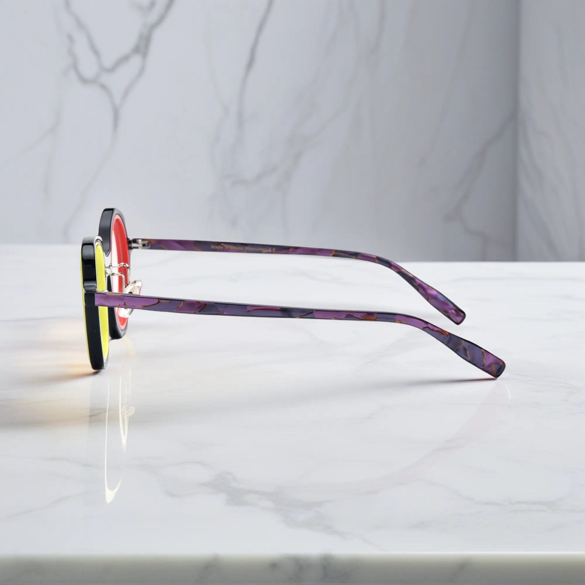 VoyueLens™ geometric eyeglasses in Black Amber color, side view showing dual-tone design and spring hinges and temples.