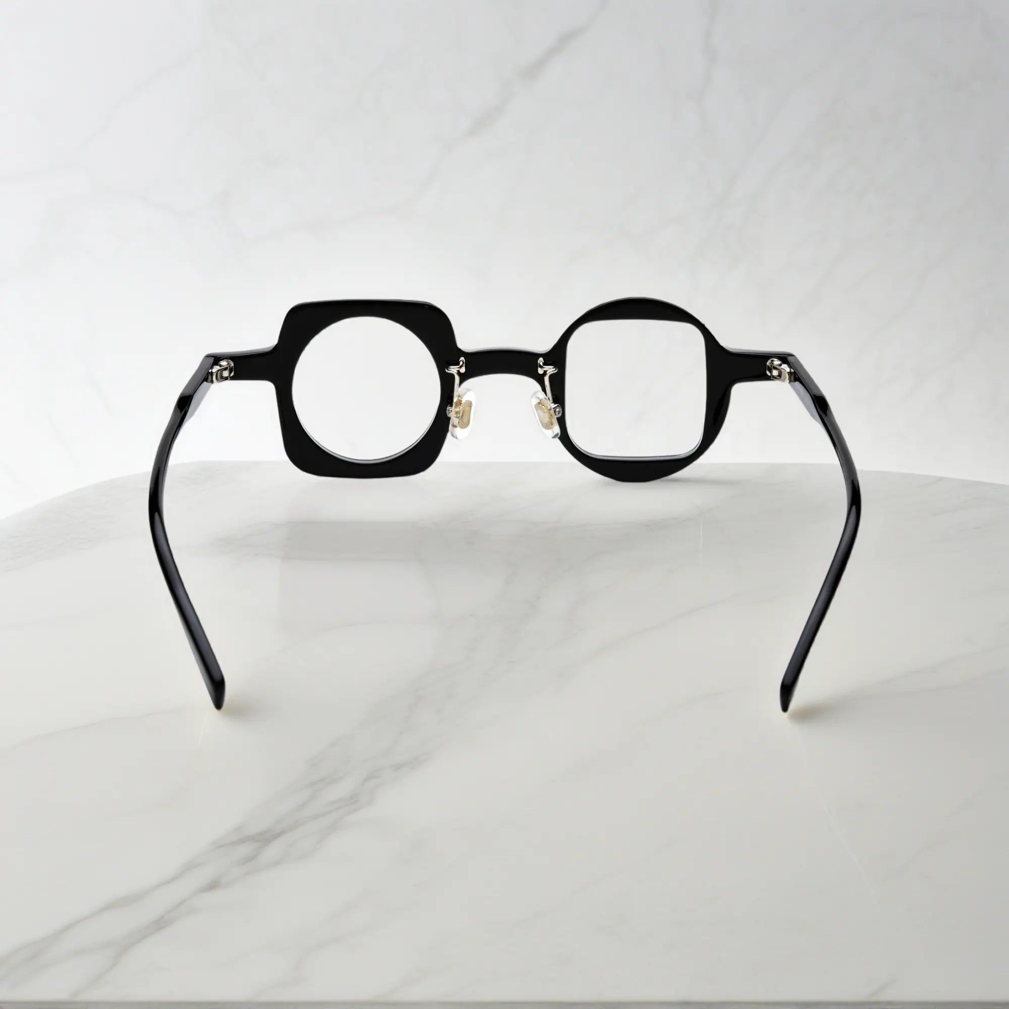 Back view showing the nano-polished black acetate frame of VoyueLens asymmetrical eyeglasses with ergonomic silicone nose pads.