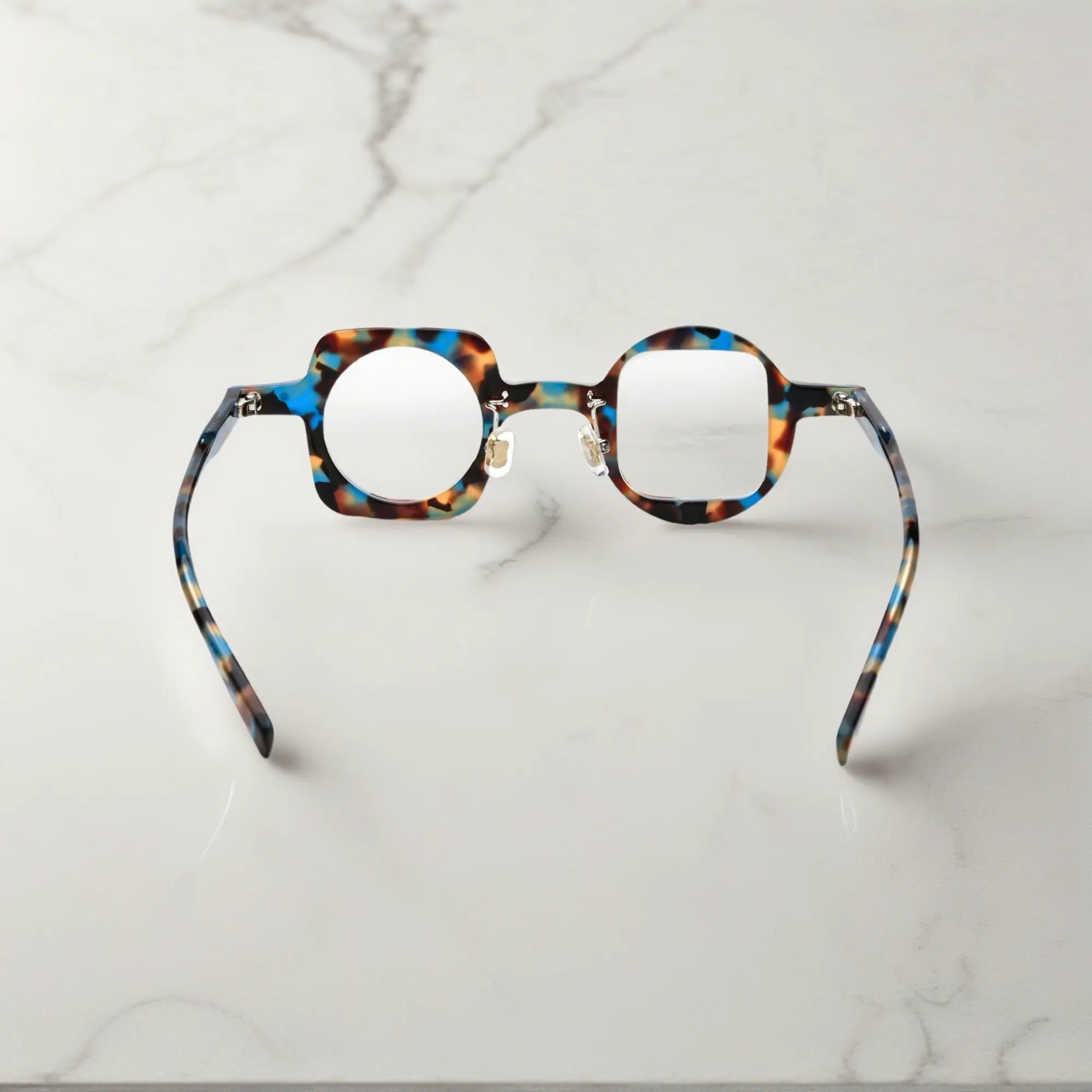 Back view highlighting the blue tortoise colorway of VoyueLens asymmetrical glasses with comfortable silicone pads and sturdy hinges.