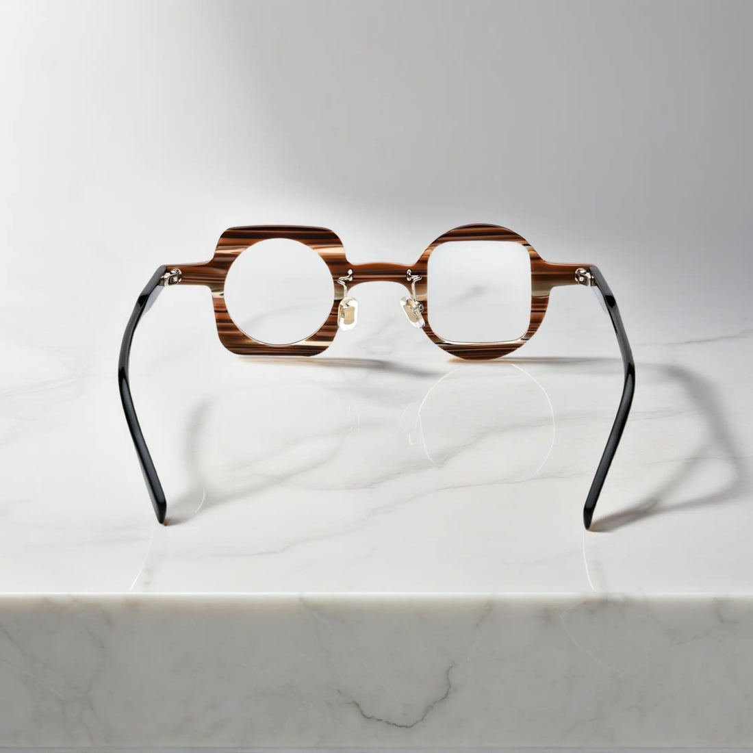 back view of VoyueLens asymmetrical brown stripe glasses showing nano-polished acetate frame, ergonomic silicone nose pads, and standard metal hinge.