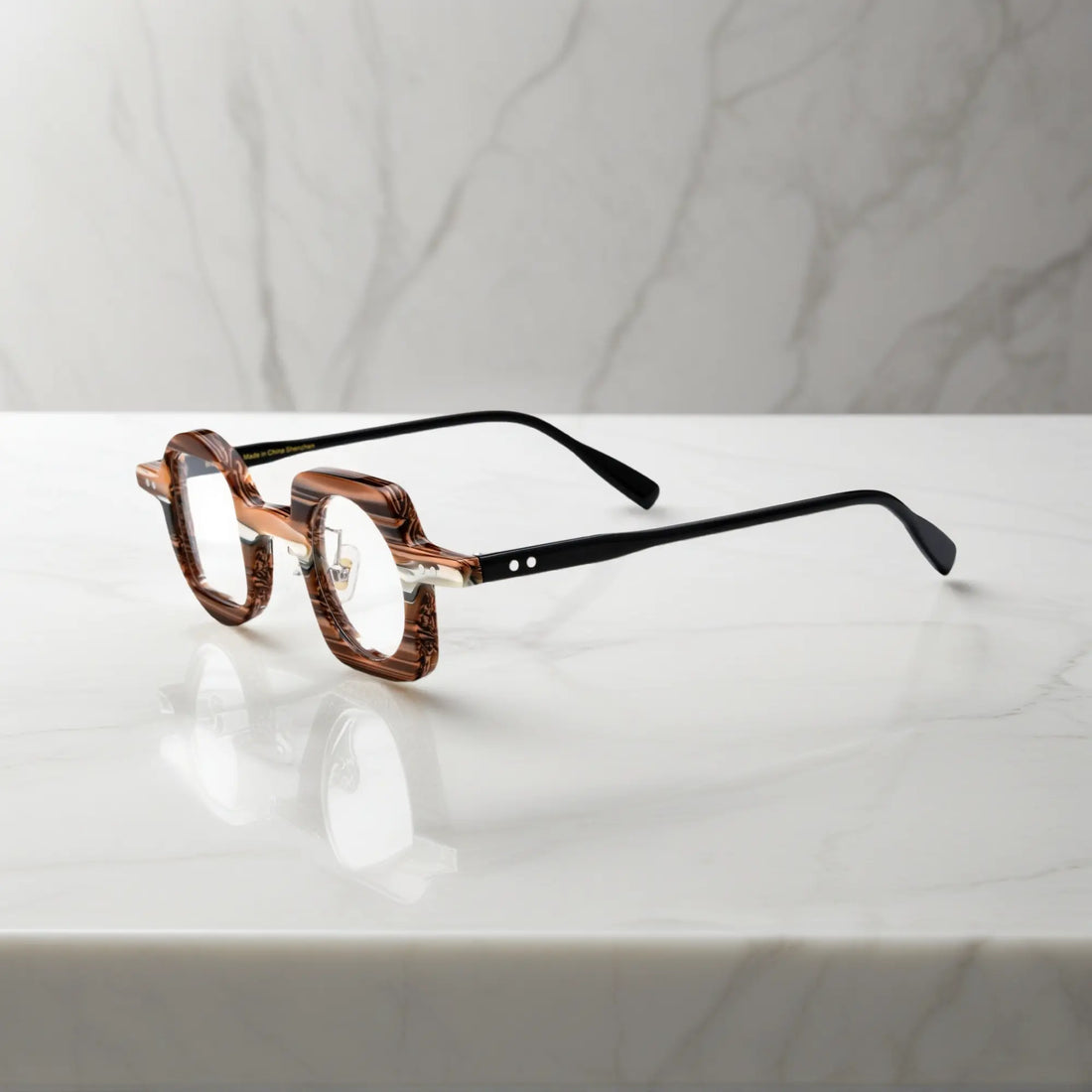 Side profile of VoyueLens asymmetrical brown stripe glasses showing nano-polished acetate frame, ergonomic silicone nose pads, and standard metal hinge.