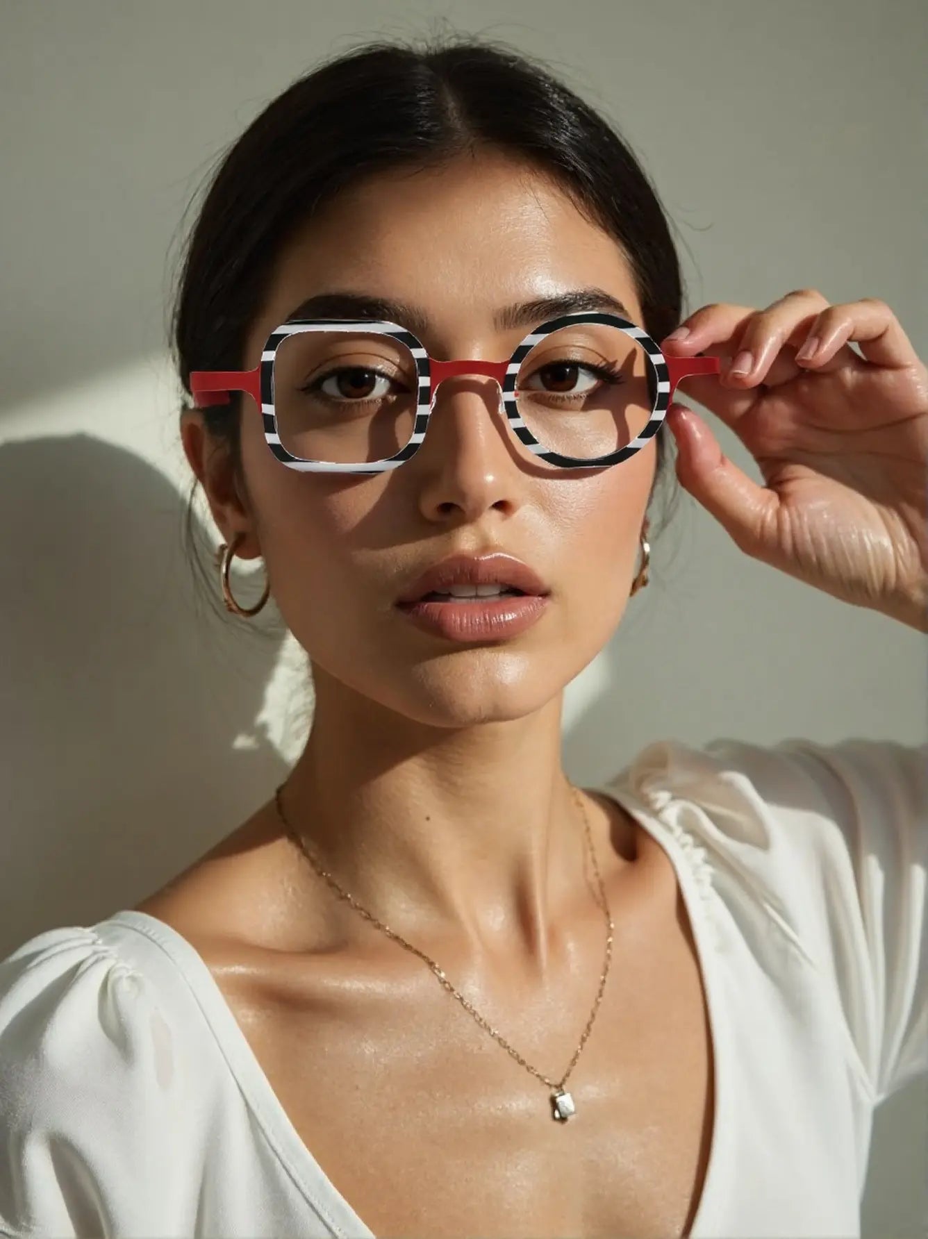 Model wearing Candy Stripe Red asymmetric eyeglasses in acetate and titanium blend.