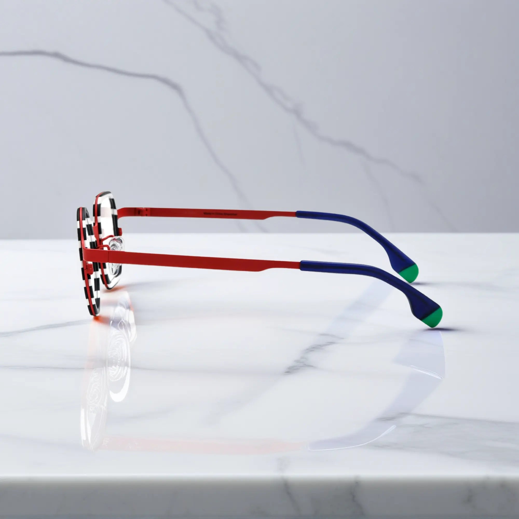 Side profile showing the titanium temple structure and gradient tips of Candy Stripe Red.