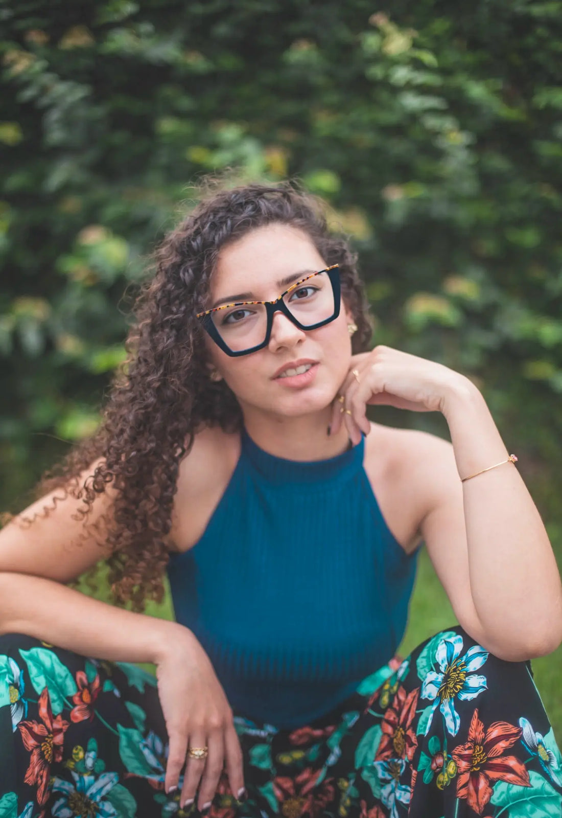 Fashion lifestyle image of a woman wearing Black-Blue Accent VoyueLens™ cat-eye glasses, combining professional elegance and youth style