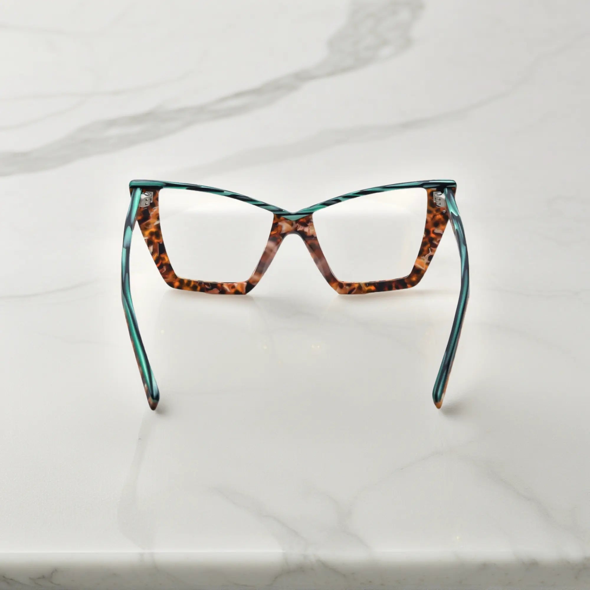 Rear view of VoyueLens™ oversized emerald tortoise cat-eye frame showing spring hinges and premium acetate arms
