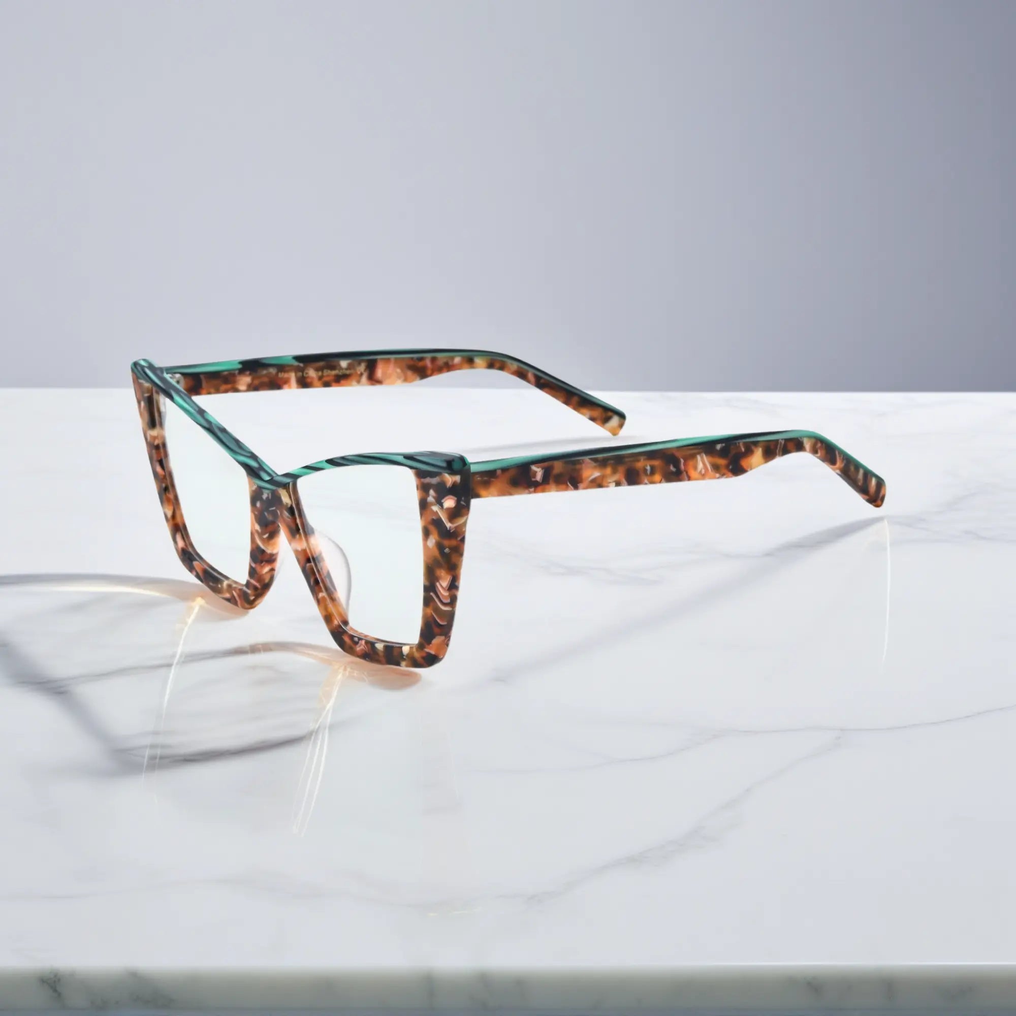 Side view of VoyueLens™ cat-eye glasses in emerald tortoise, highlighting the sleek acetate temples and lightweight design