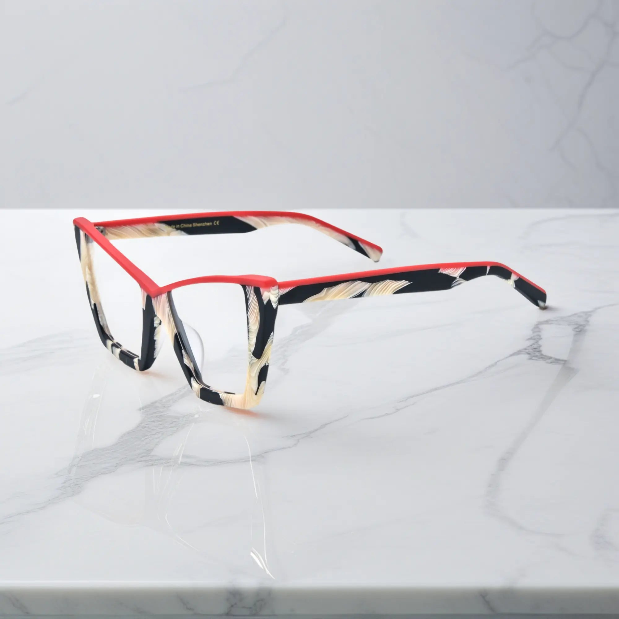 Side profile of VoyueLens™ Scarlet Ivory Feather glasses, with vivid red detail and sculptural full-rim acetate temples