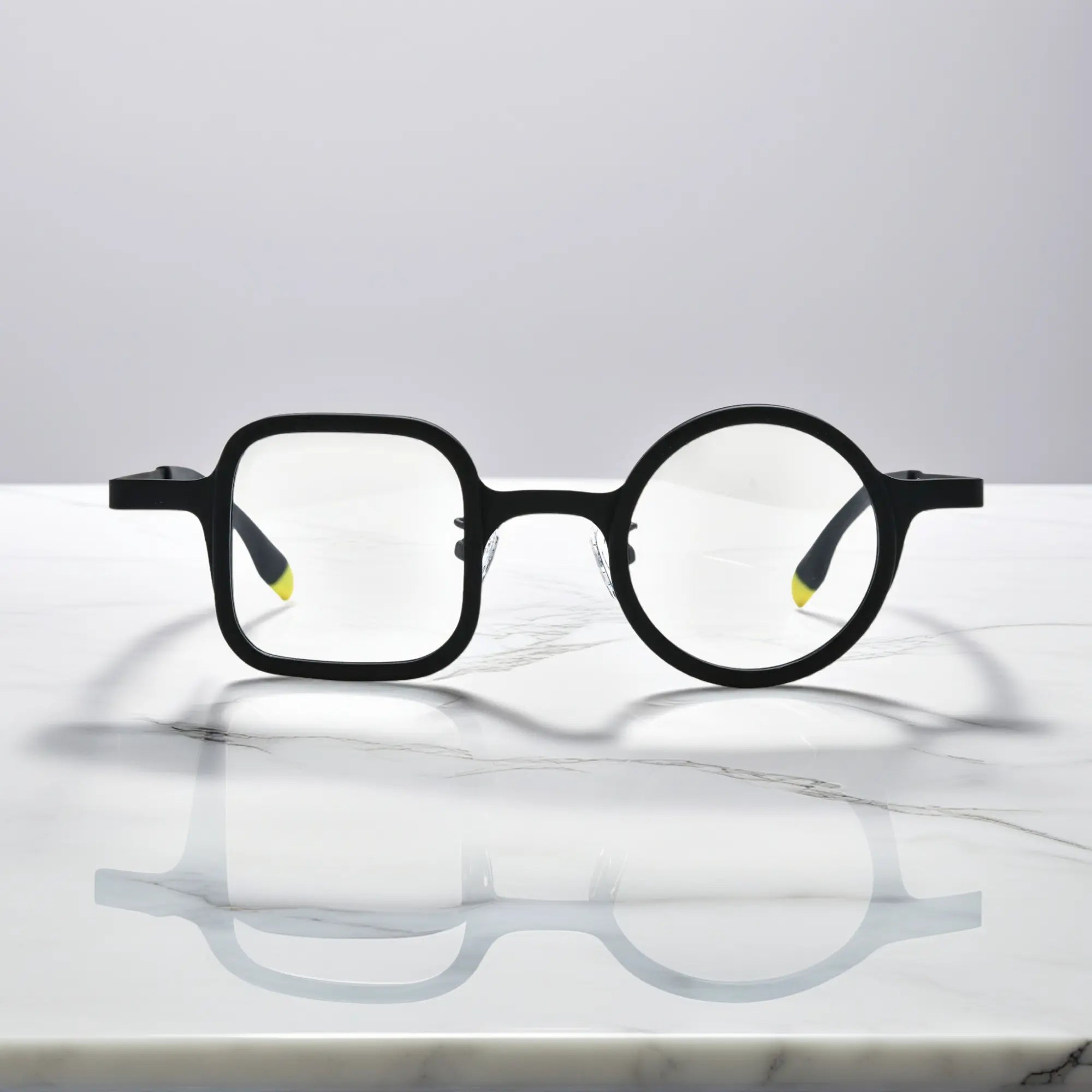 Bold front view of Charcoal Black eyeglasses with matte acetate front and titanium arms.