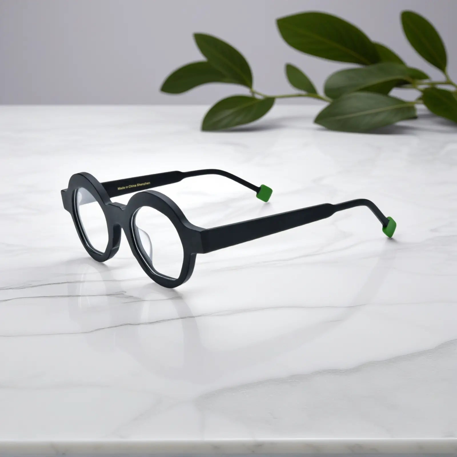 Side profile of the Charcoal Black matte frame showing tapered temples, lightweight design, and subtle texture