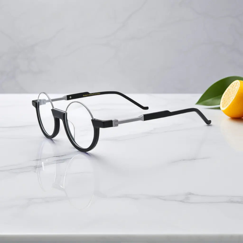 Side profile highlighting the silver-toned bridge and sharp black temple arms of Charcoal Silver round frames.